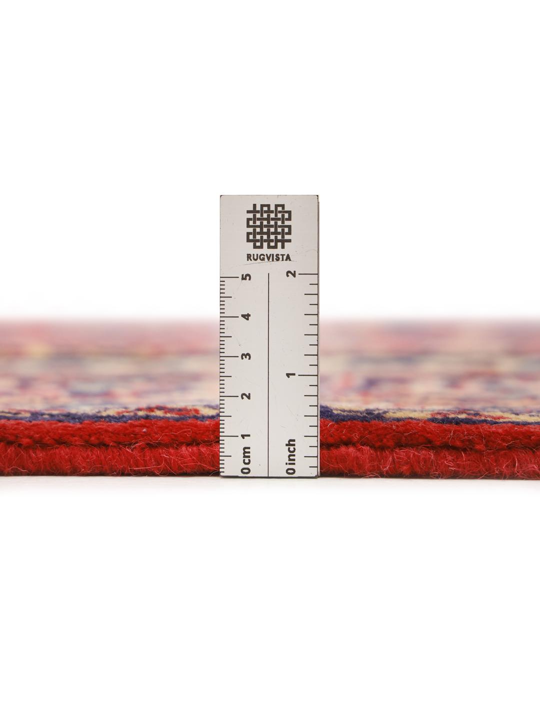 A beautiful, one-of-a-kind hand-knotted Sarough rug from the Middle East featuring a vibrant red field with intricate blue and cream floral motifs.