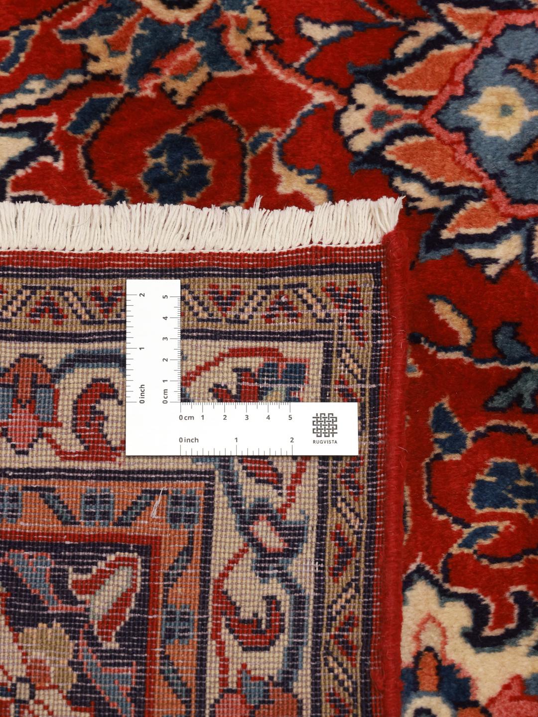 A beautiful, one-of-a-kind hand-knotted Sarough rug from the Middle East featuring a vibrant red field with intricate blue and cream floral motifs.