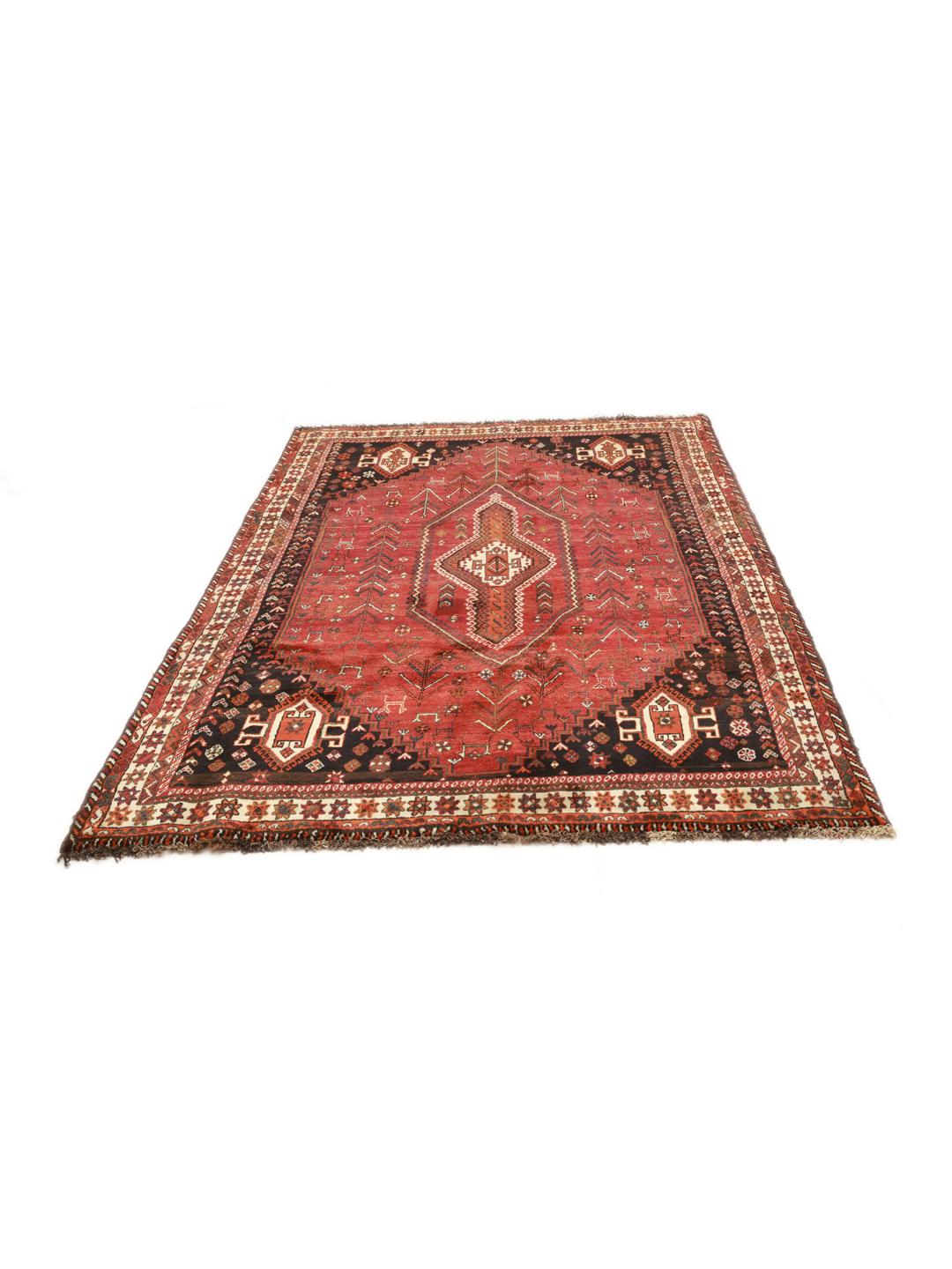A hand knotted Ghashghai rug from the Middle East featuring a vibrant red and black design