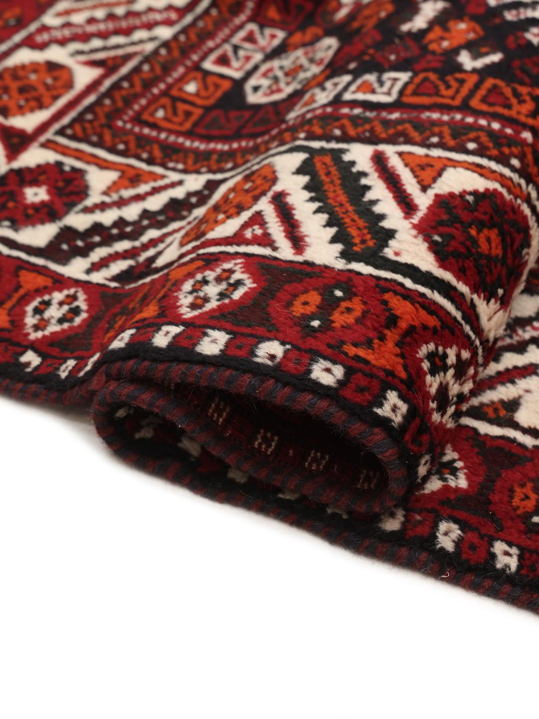 Hand-knotted Middle Eastern rug in dark-red with geometric medallion patterns