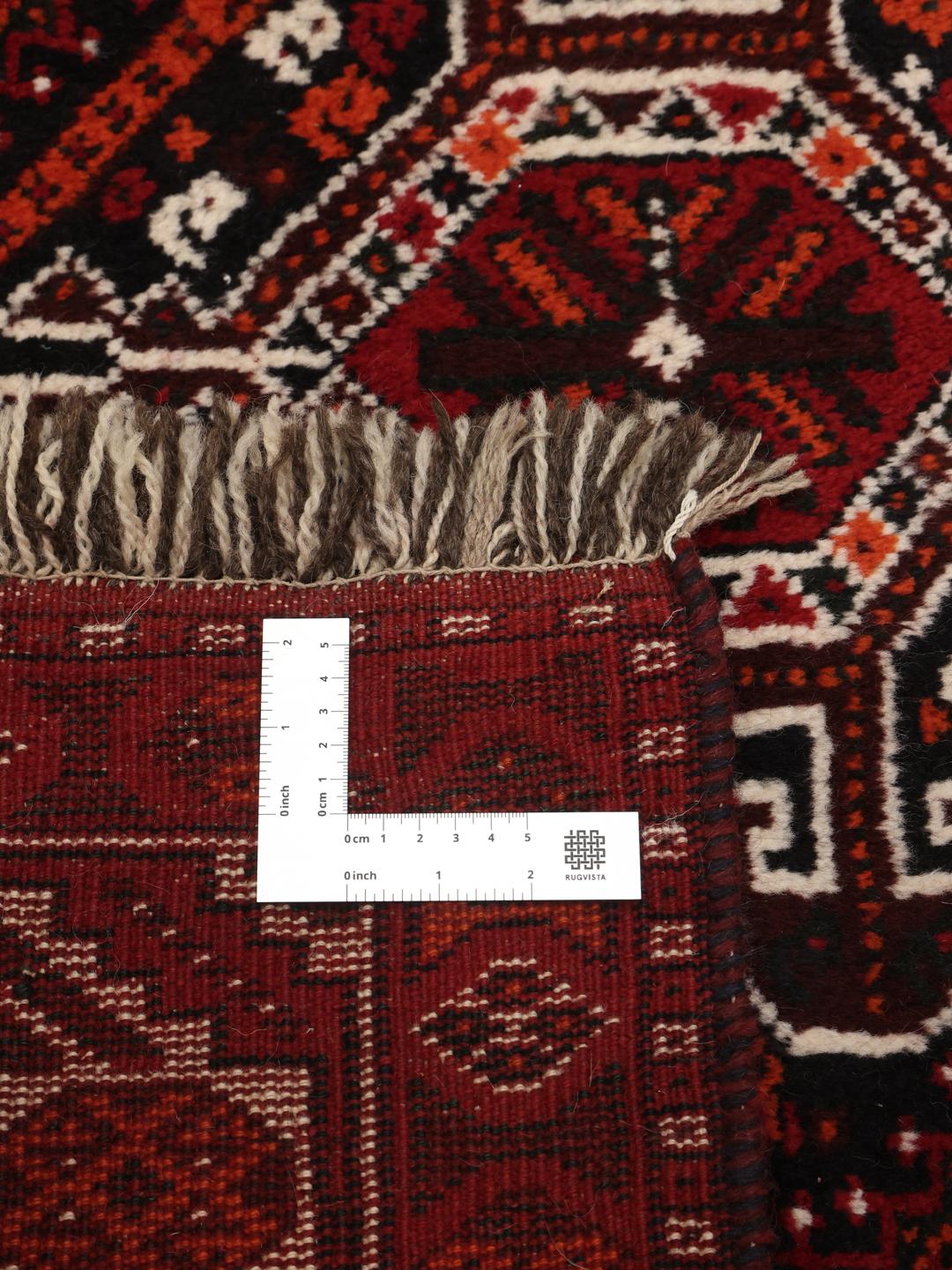 Hand-knotted Middle Eastern rug in dark-red with geometric medallion patterns