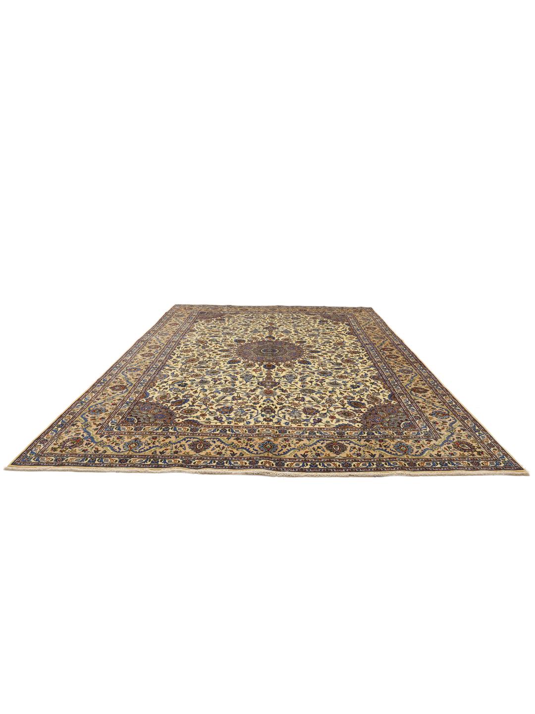 A large hand-knotted beige Mashad rug from the Middle East with intricate floral patterns.