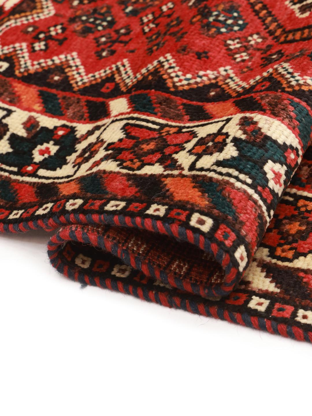 Hand-knotted Middle Eastern rug in dark-red and black tones