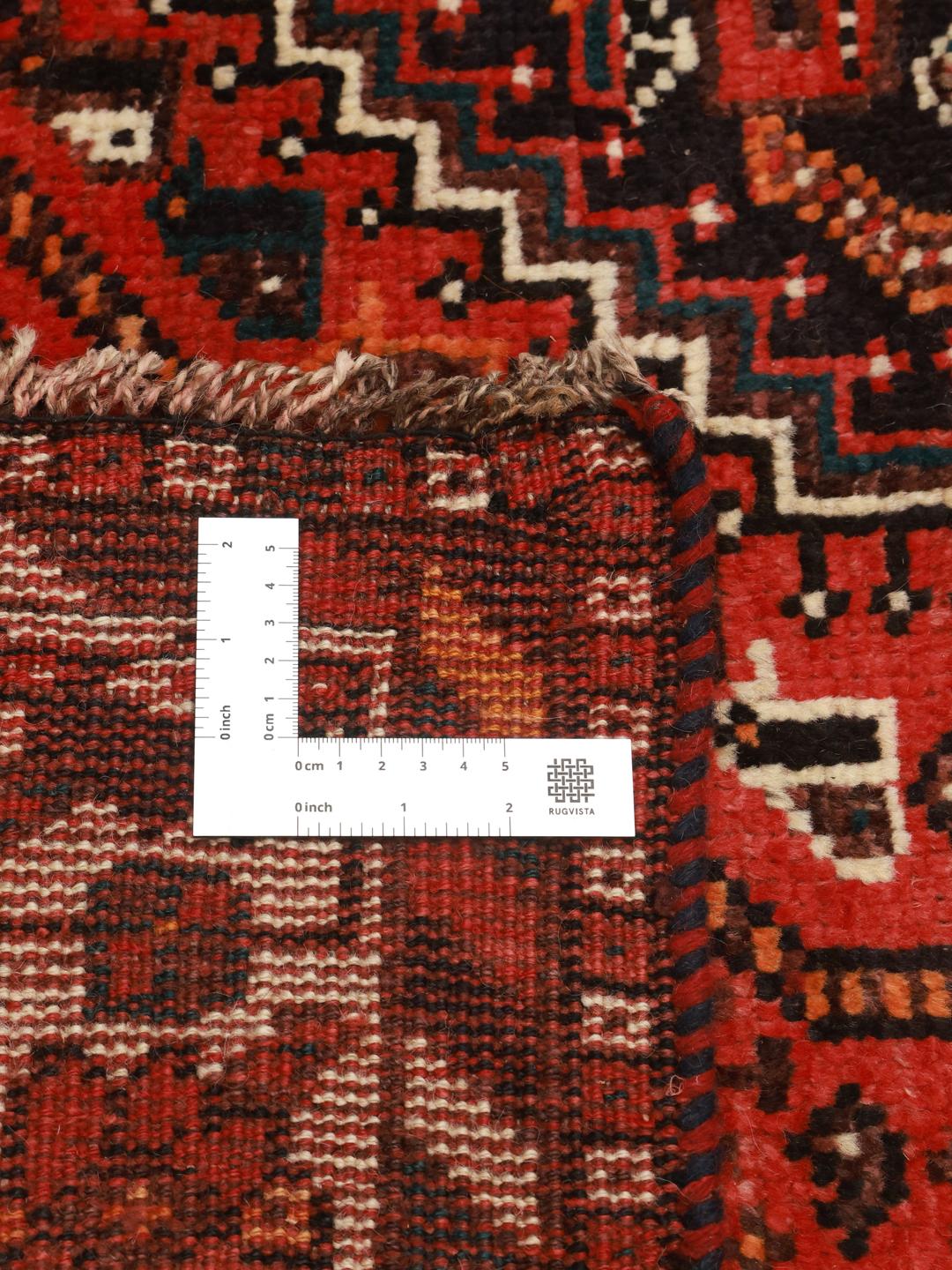 Hand-knotted Middle Eastern rug in dark-red and black tones