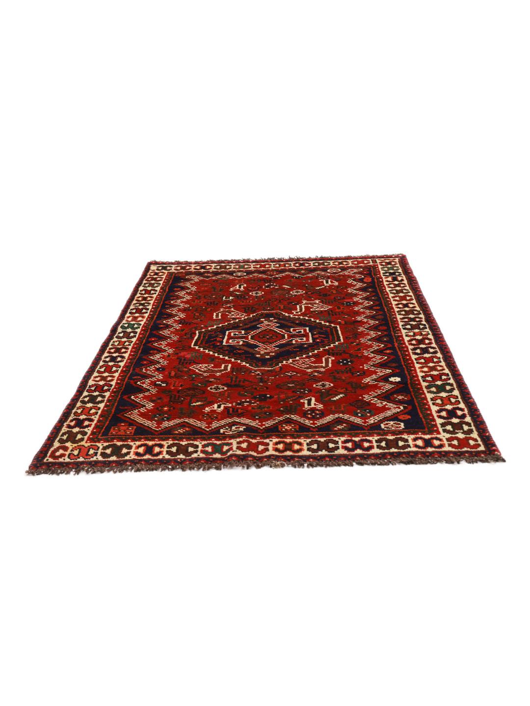 Hand-knotted Shiraz rug from the Middle East featuring a vibrant red field and tribal motifs