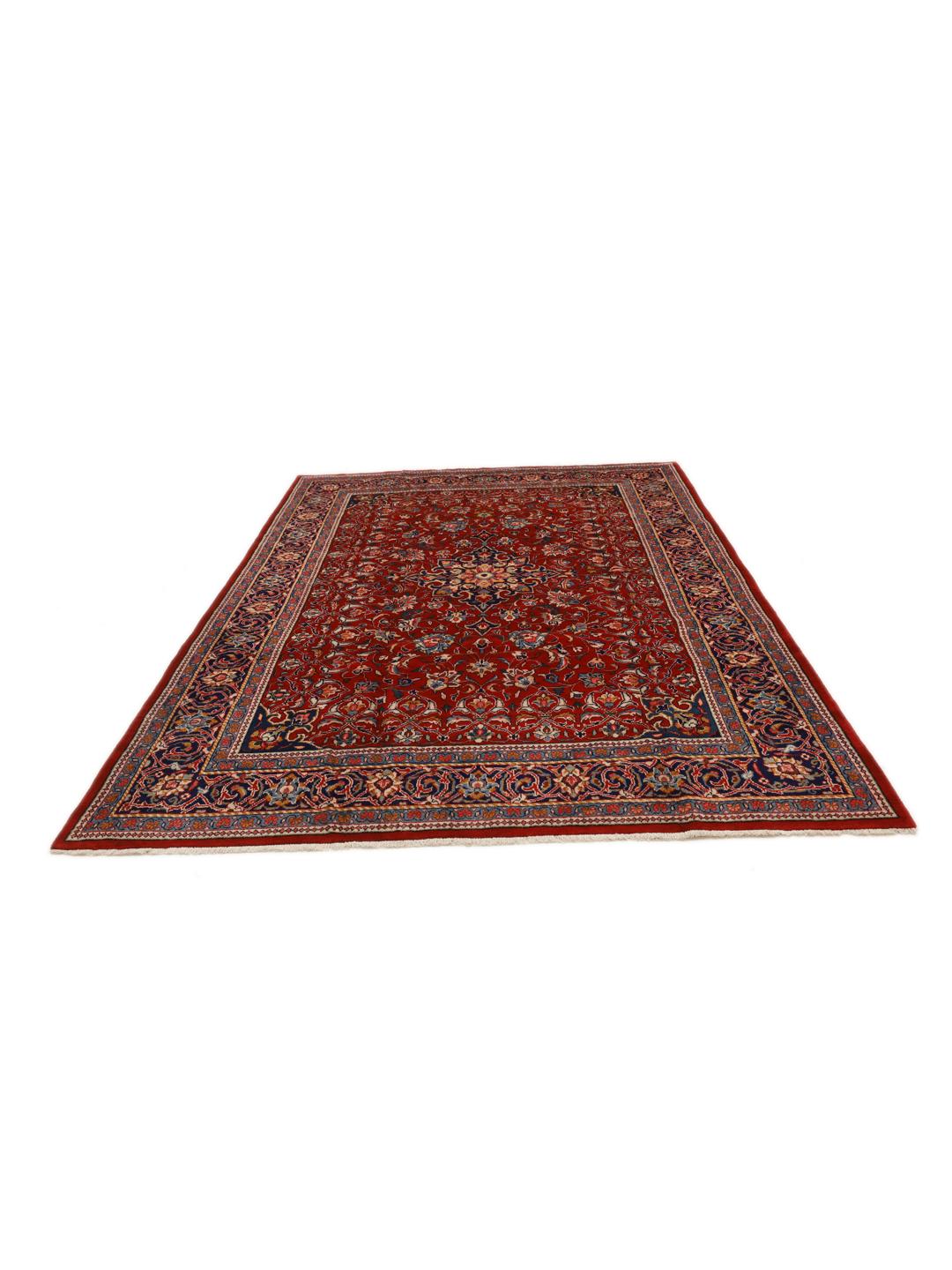 A hand-knotted Sarough rug from the Middle East featuring a vibrant red field with intricate floral patterns.
