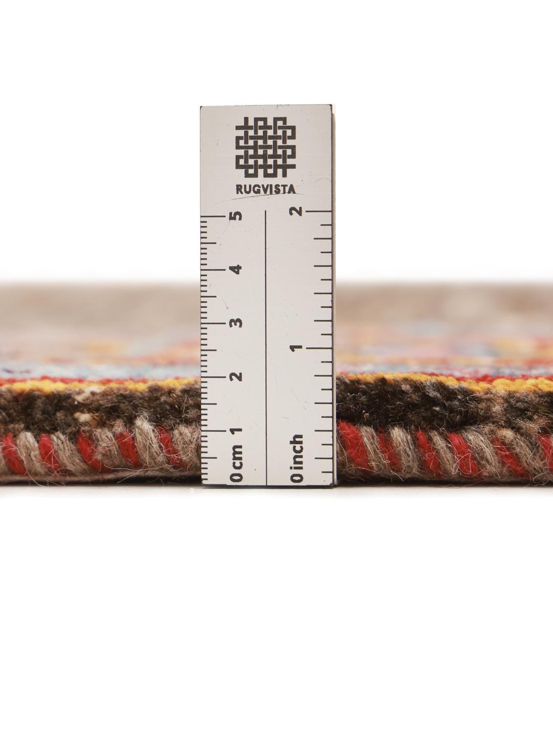 A rectangular Gabbeh rug from the Middle East with a brown field and vibrant border.