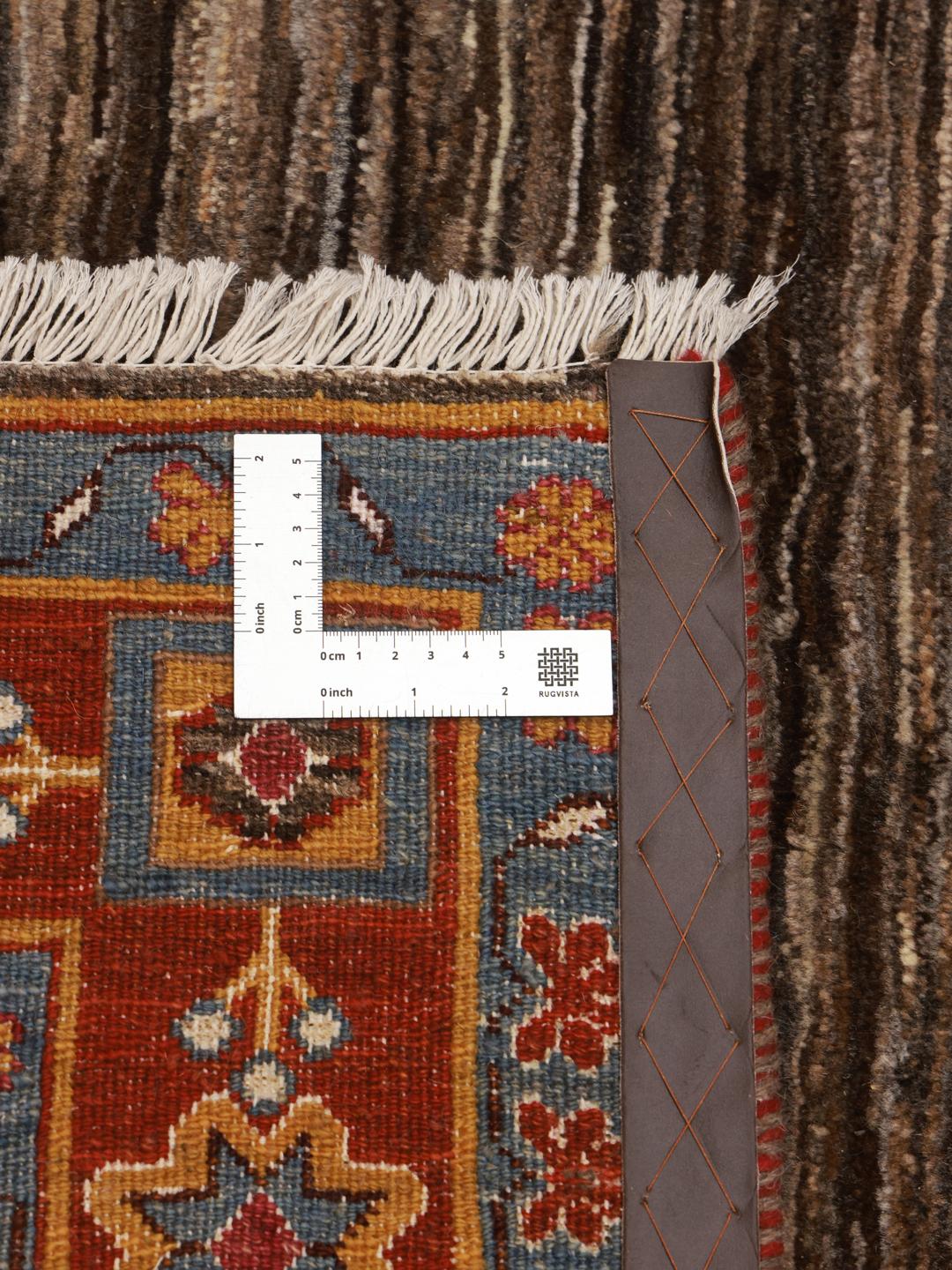 A rectangular Gabbeh rug from the Middle East with a brown field and vibrant border.