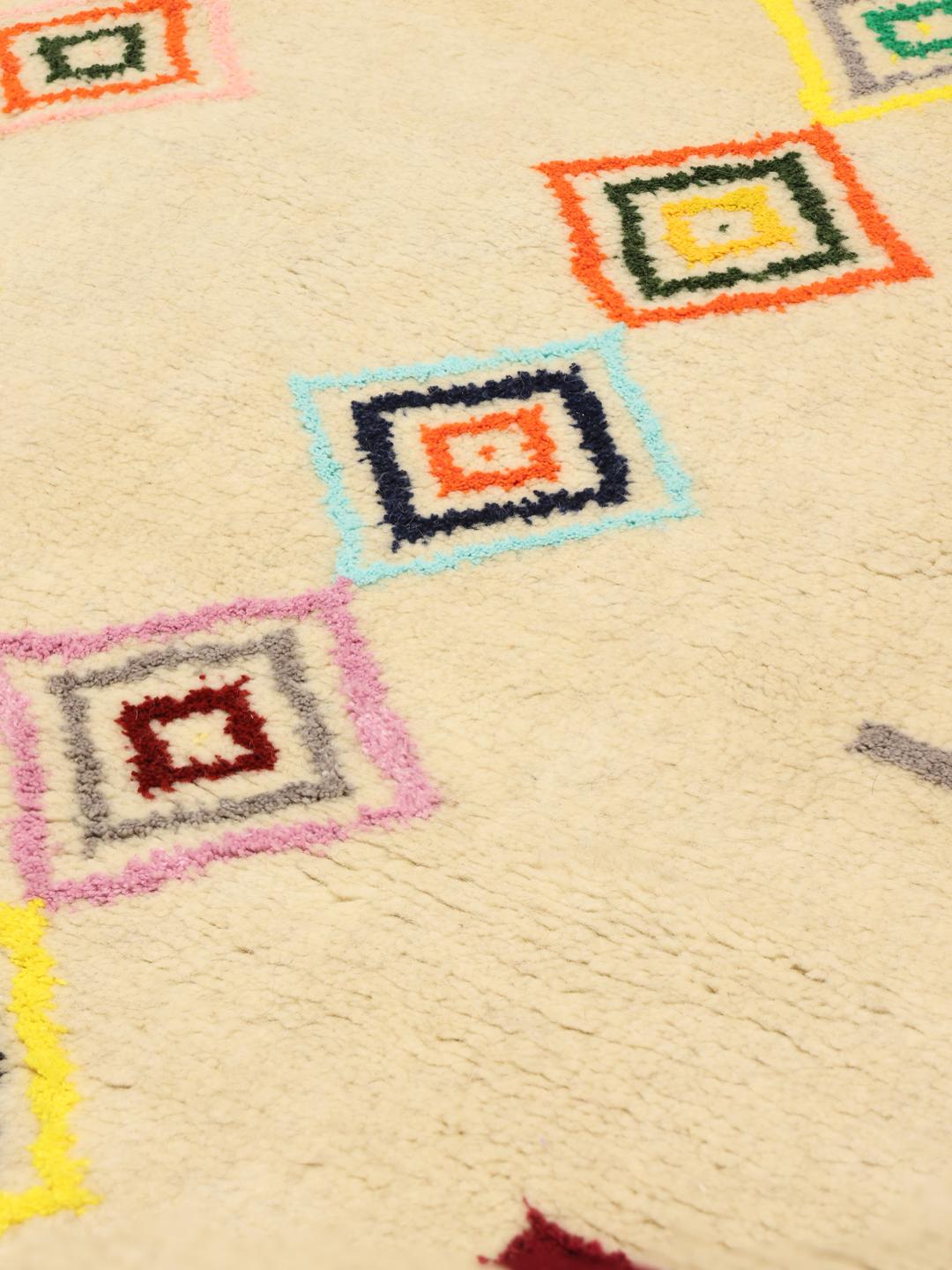 A one-of-a-kind hand-knotted Gabbeh rug from the Middle East featuring colourful geometric diamond motifs on a neutral background.