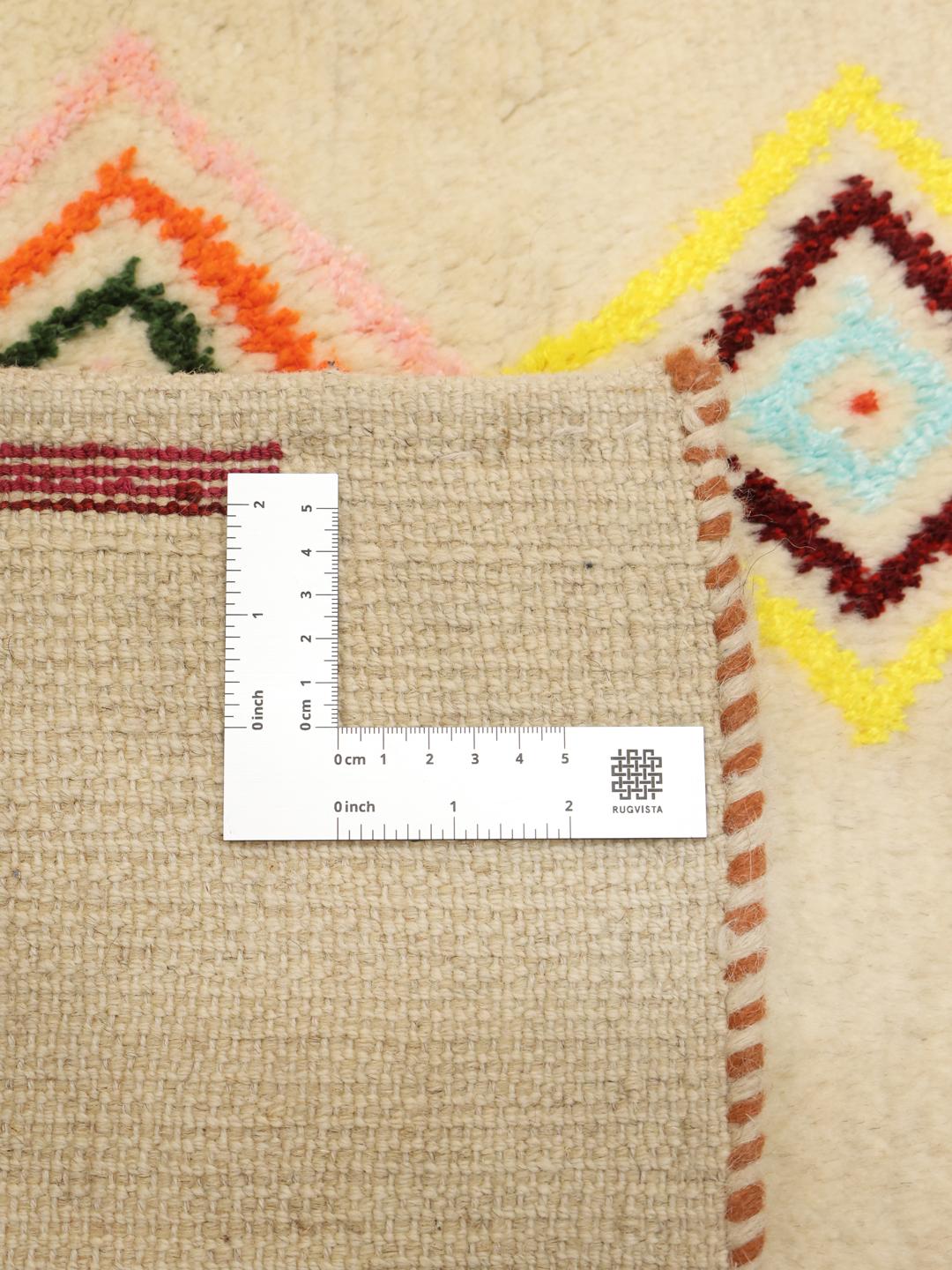 A one-of-a-kind hand-knotted Gabbeh rug from the Middle East featuring colourful geometric diamond motifs on a neutral background.