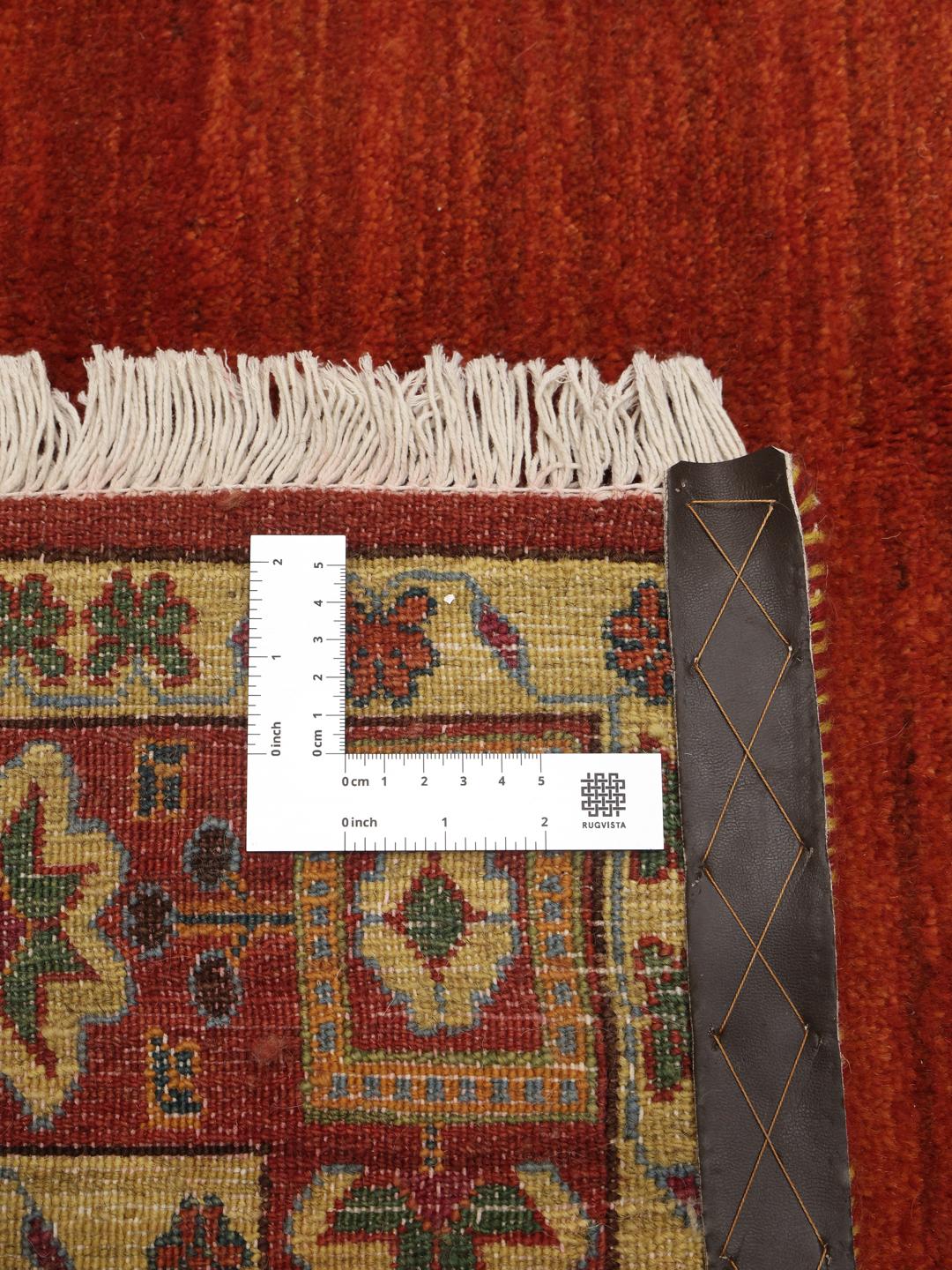 A hand-knotted Gabbeh Wool rug from the Middle East featuring a vibrant red field and geometric borders.