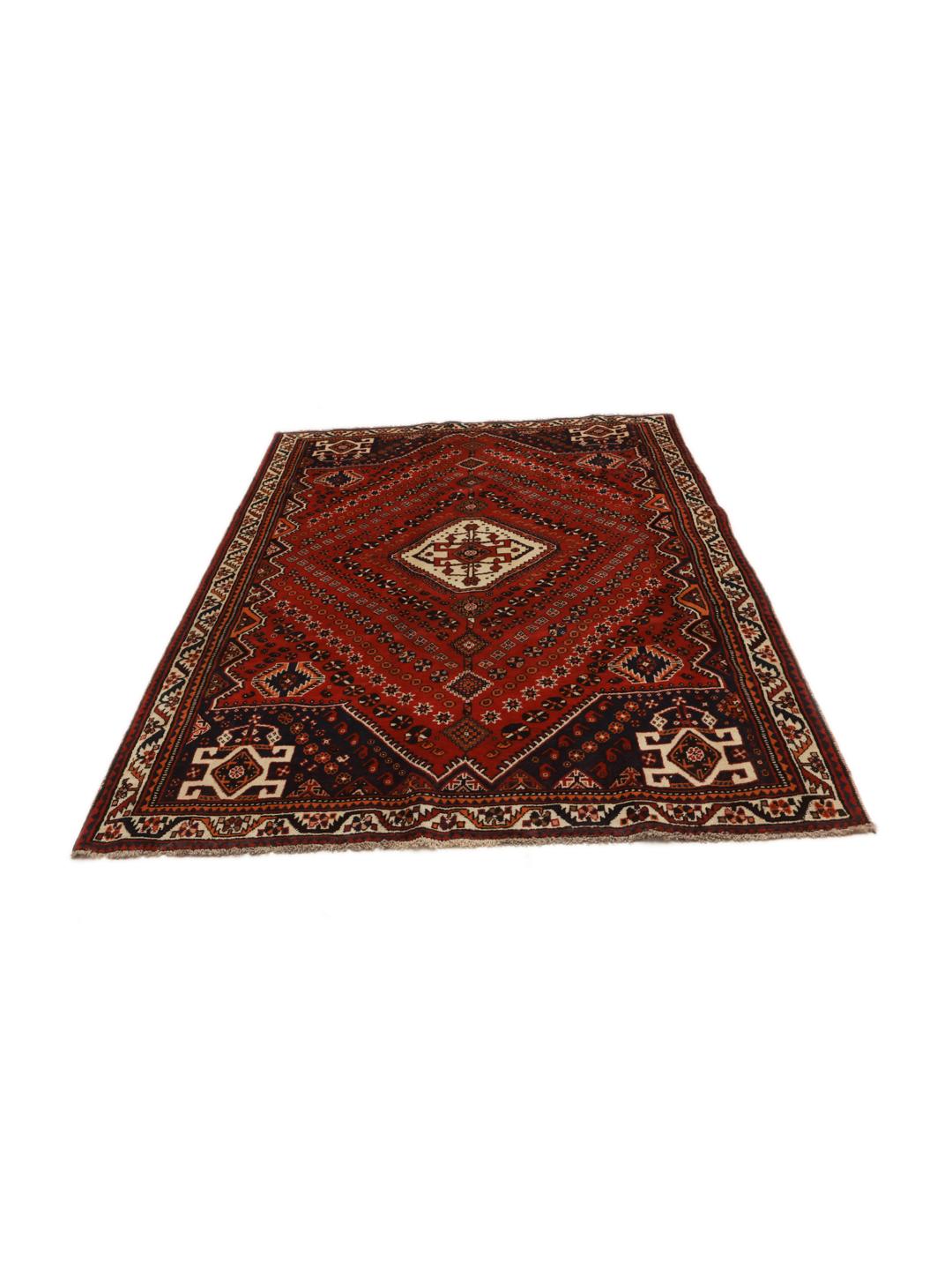Hand-knotted Qashqai rug from the Middle East featuring a dark-red field and geometric patterns.