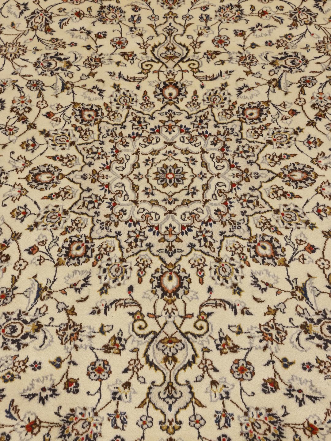 Hand-knotted Keshan rug from the Middle East with a beige field and intricate floral pattern