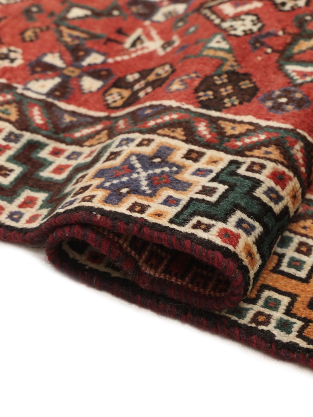 Hand knotted Shiraz rug from the Middle East featuring a vibrant red field with geometric medallions