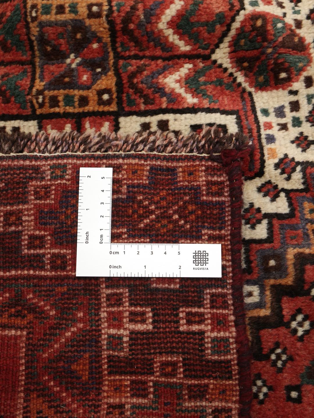 Hand knotted Shiraz rug from the Middle East featuring a vibrant red field with geometric medallions