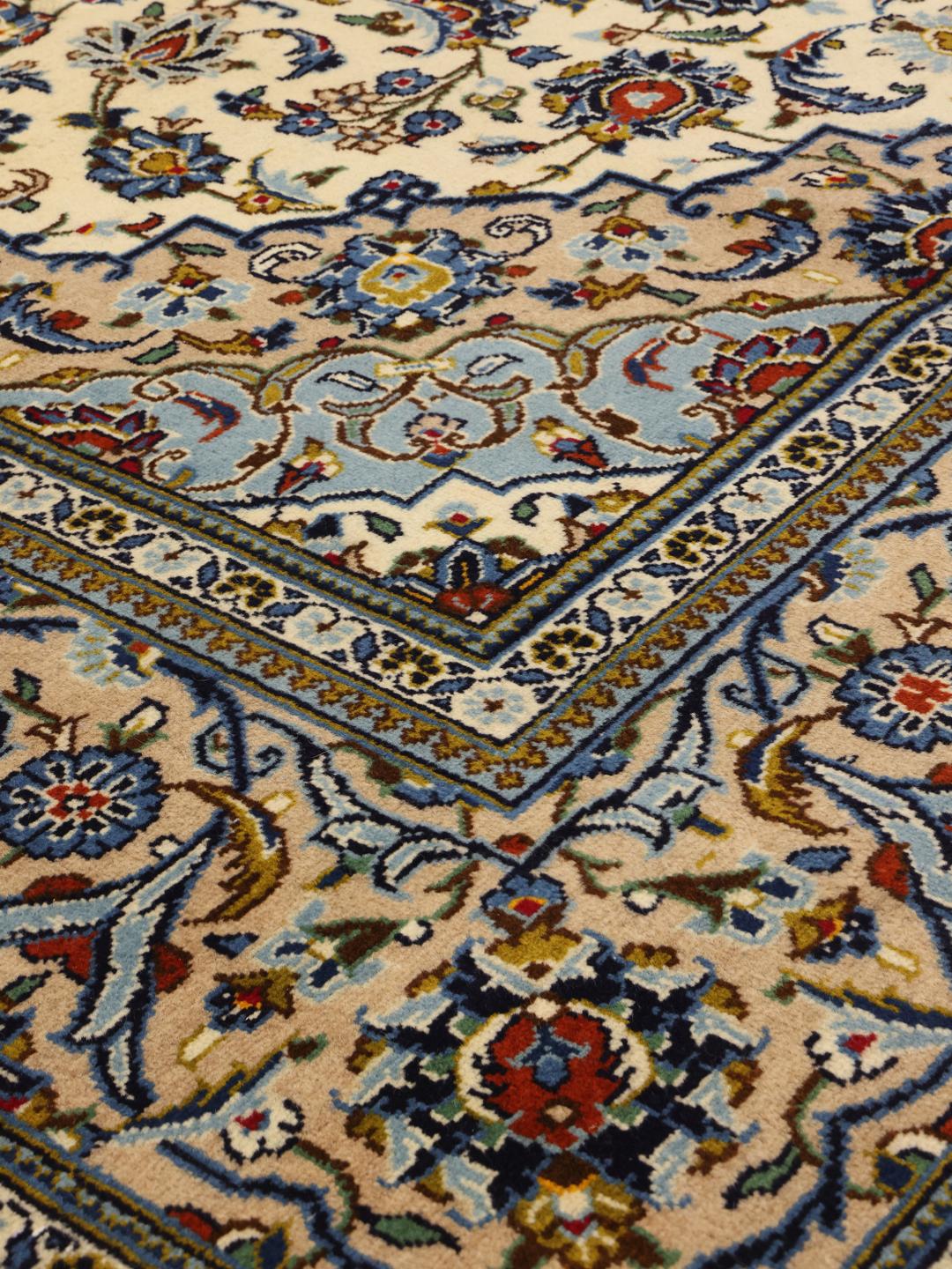 Hand-knotted Keshan rug from the Middle East with a floral medallion in beige and blue.