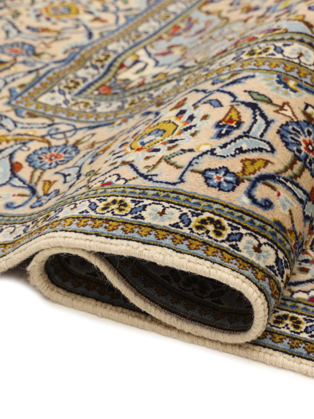 Hand-knotted Keshan rug from the Middle East with a floral medallion in beige and blue.