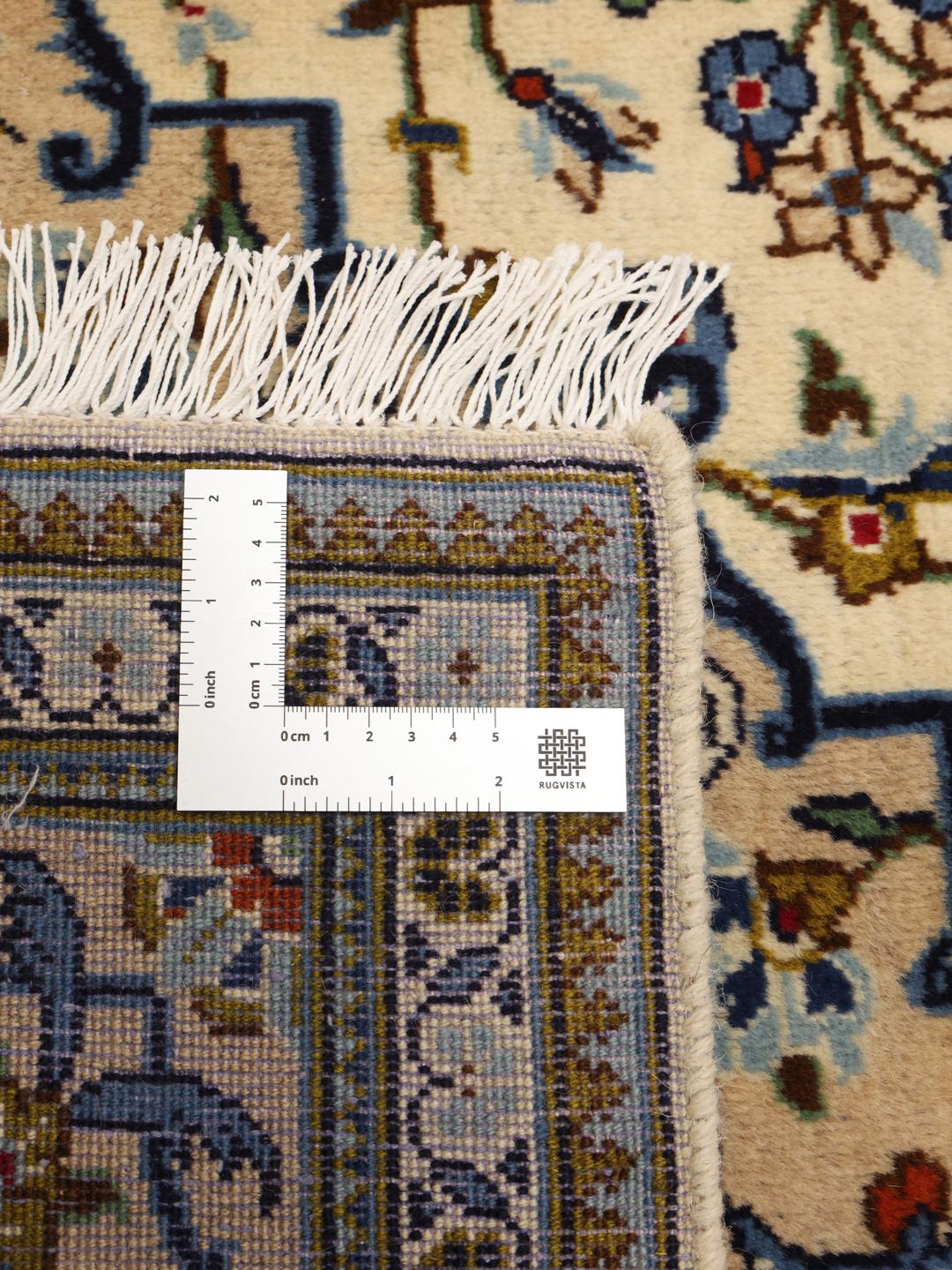 Hand-knotted Keshan rug from the Middle East with a floral medallion in beige and blue.