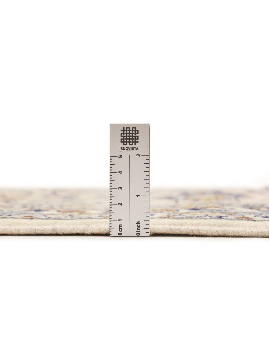 A rectangular Keshan rug from the Middle East featuring beige, blue, and brown floral patterns.