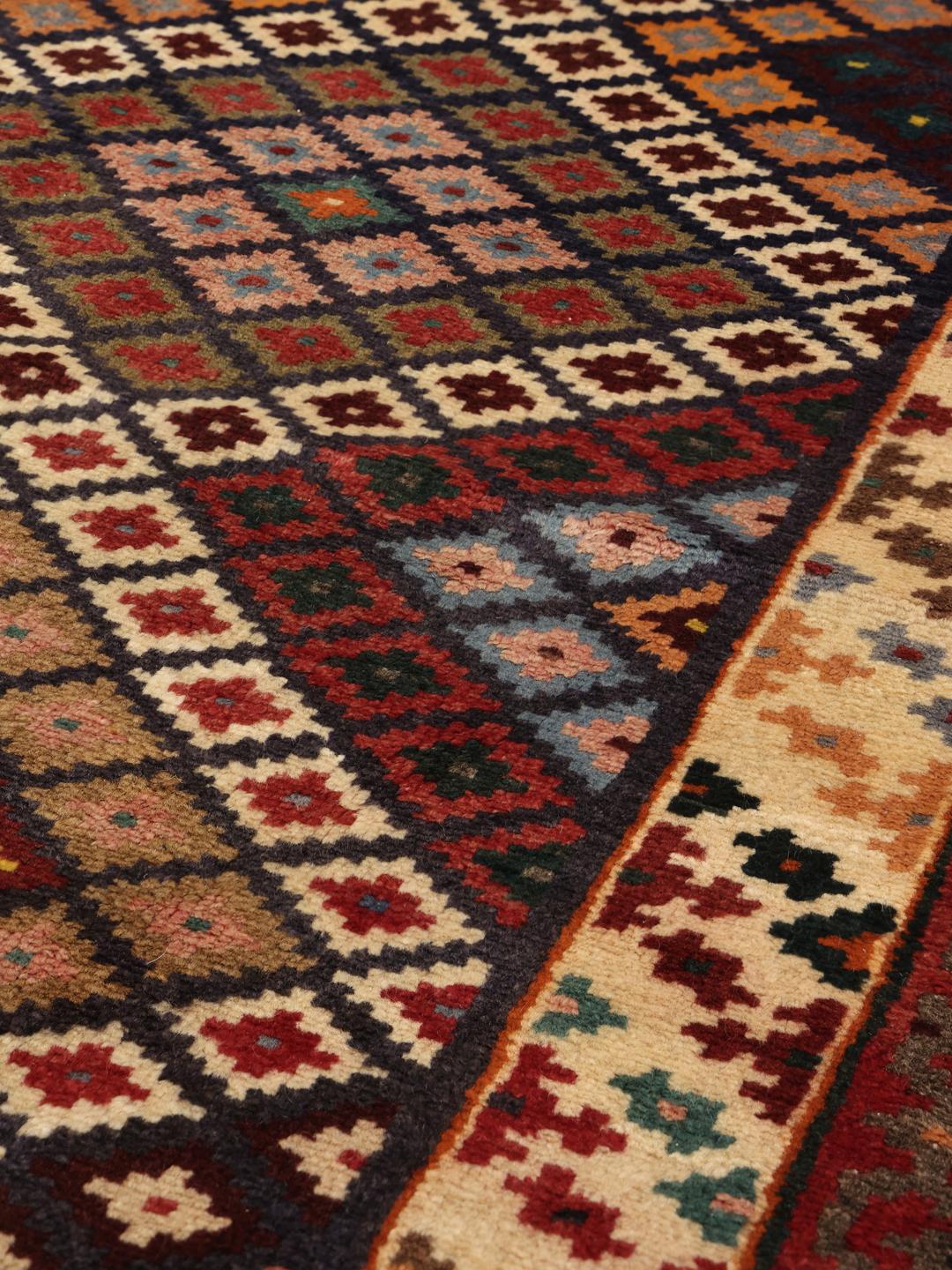 A hand-knotted Hamadan runner with a vibrant geometric pattern in multicolor wool.