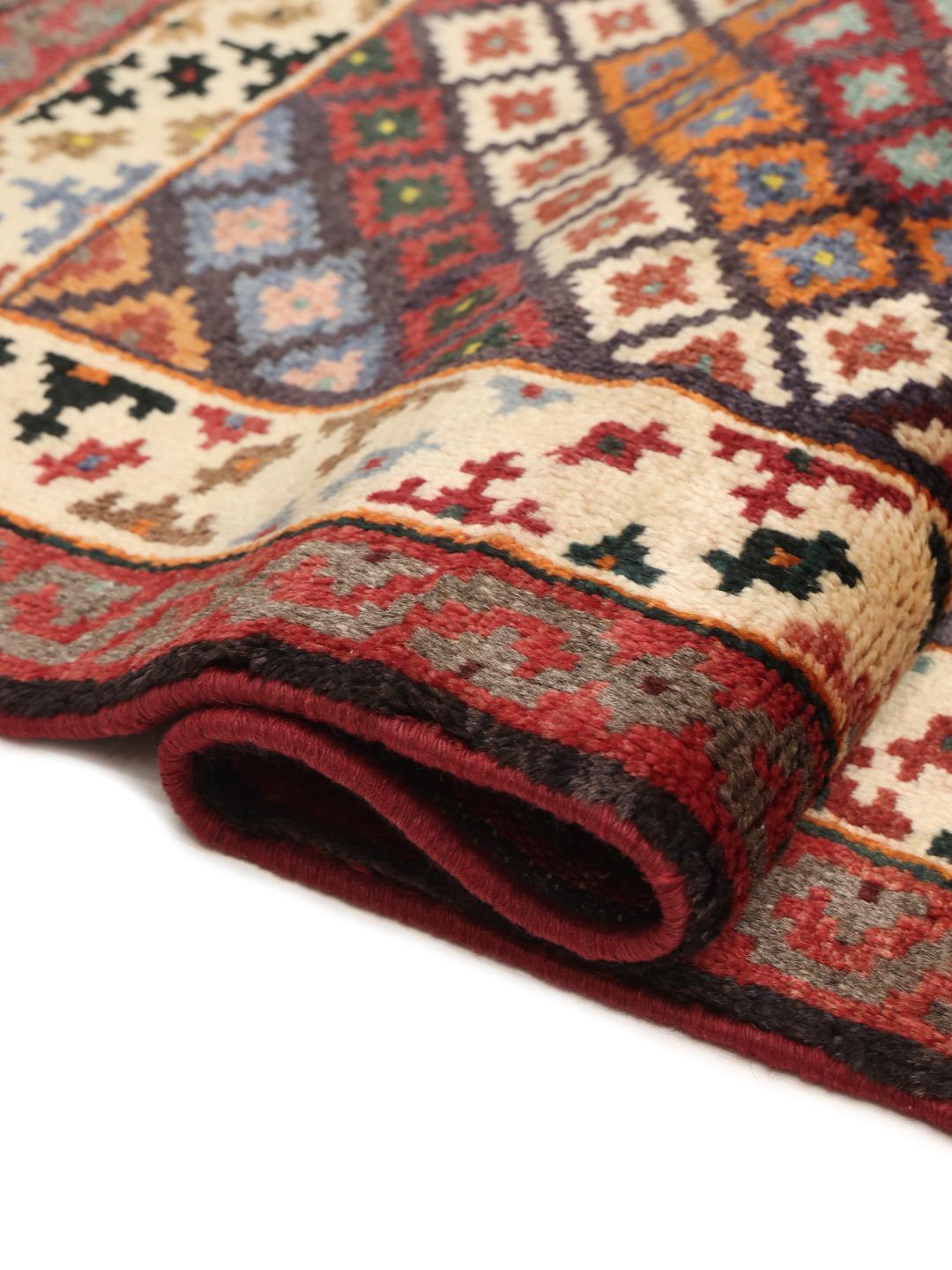 A hand-knotted Hamadan runner with a vibrant geometric pattern in multicolor wool.