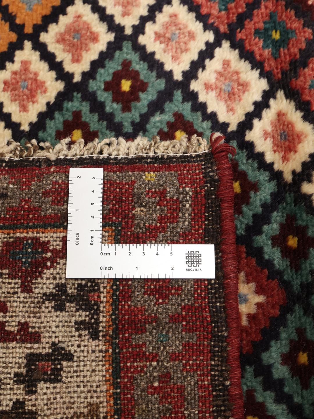 A hand-knotted Hamadan runner with a vibrant geometric pattern in multicolor wool.