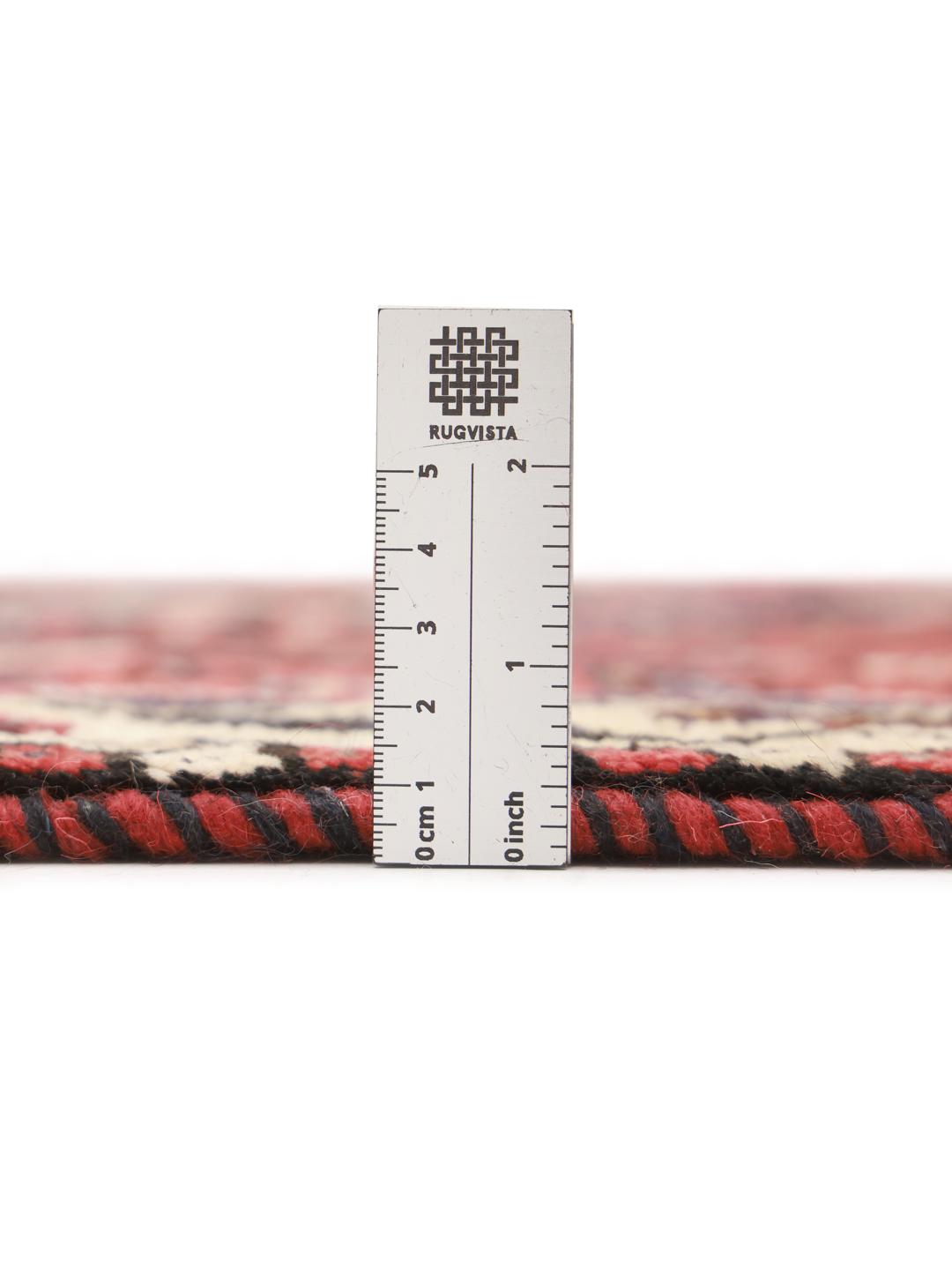 Hand-knotted Shiraz rug from the Middle East featuring a vibrant red field and geometric patterns.
