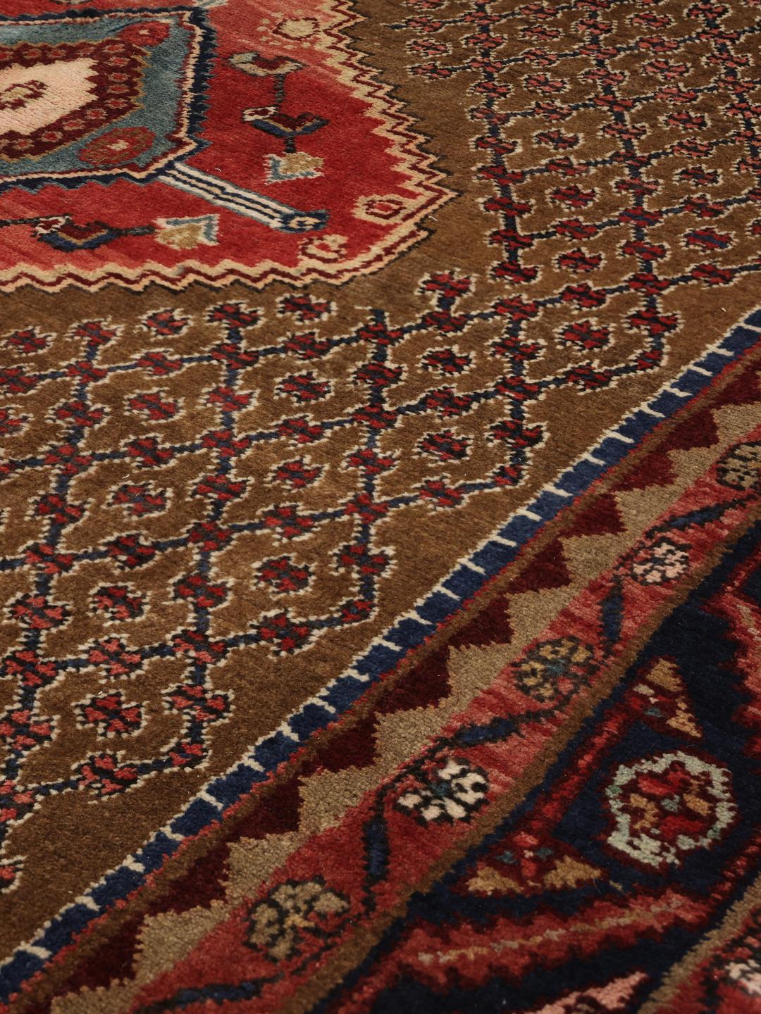 Koliai rug from the Middle East with a brown field and geometric medallion