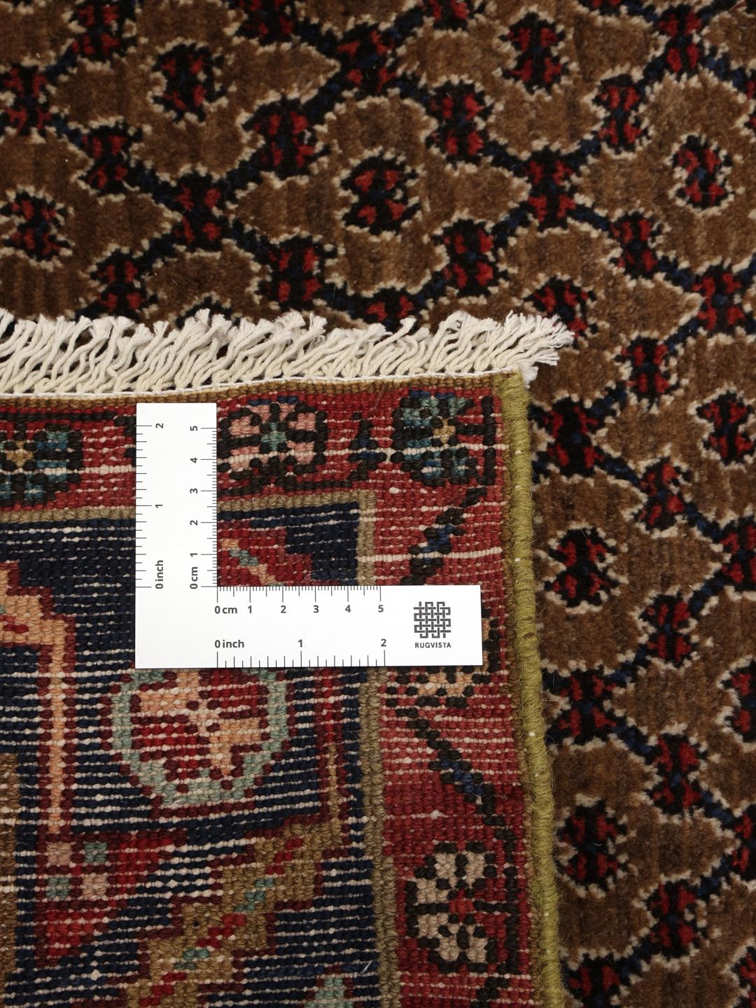 Koliai rug from the Middle East with a brown field and geometric medallion