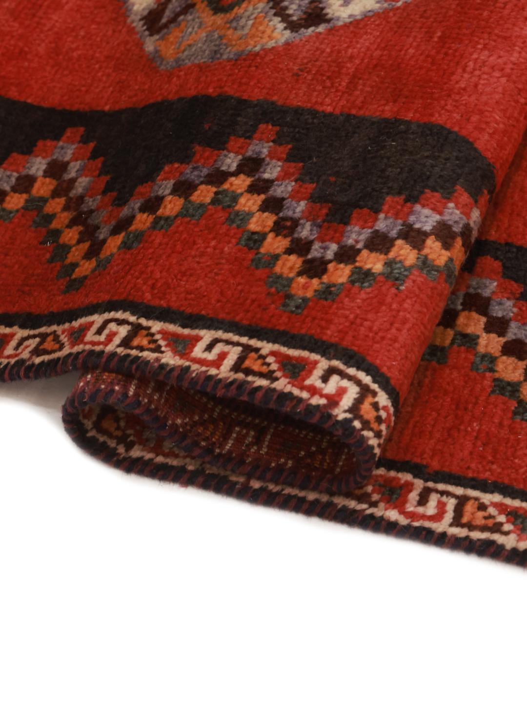 Hand-knotted Shiraz rug from the Middle East featuring geometric diamond patterns in red and black