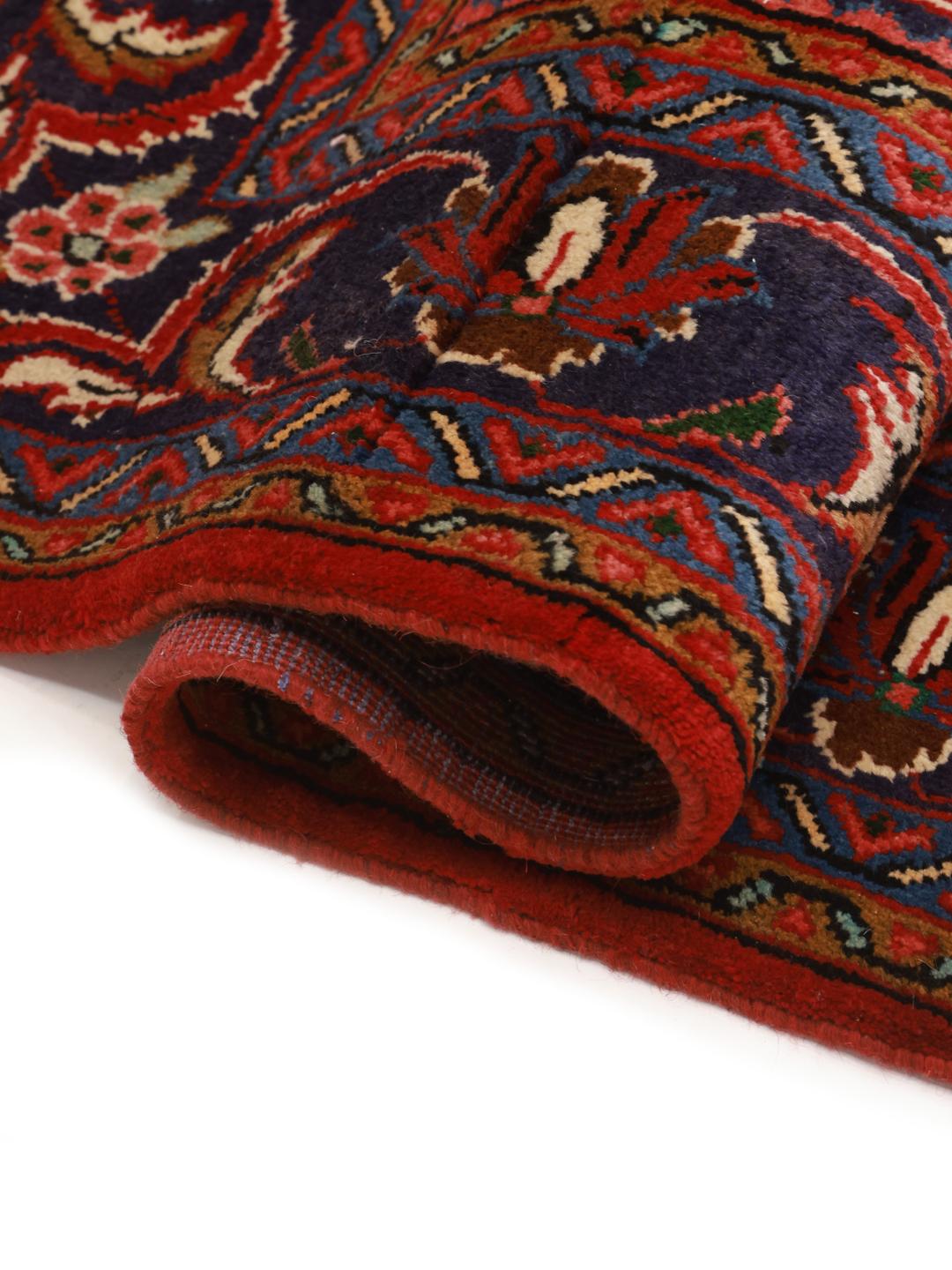 Hand-knotted Hosseinabad rug from the Middle East with a red field and decorative borders.