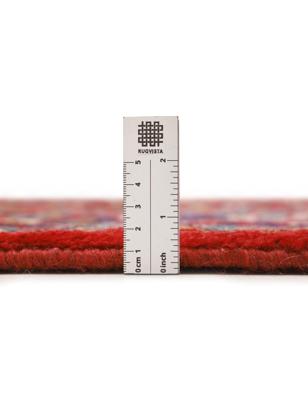 Hand-knotted Hosseinabad rug from the Middle East with a red field and decorative borders.