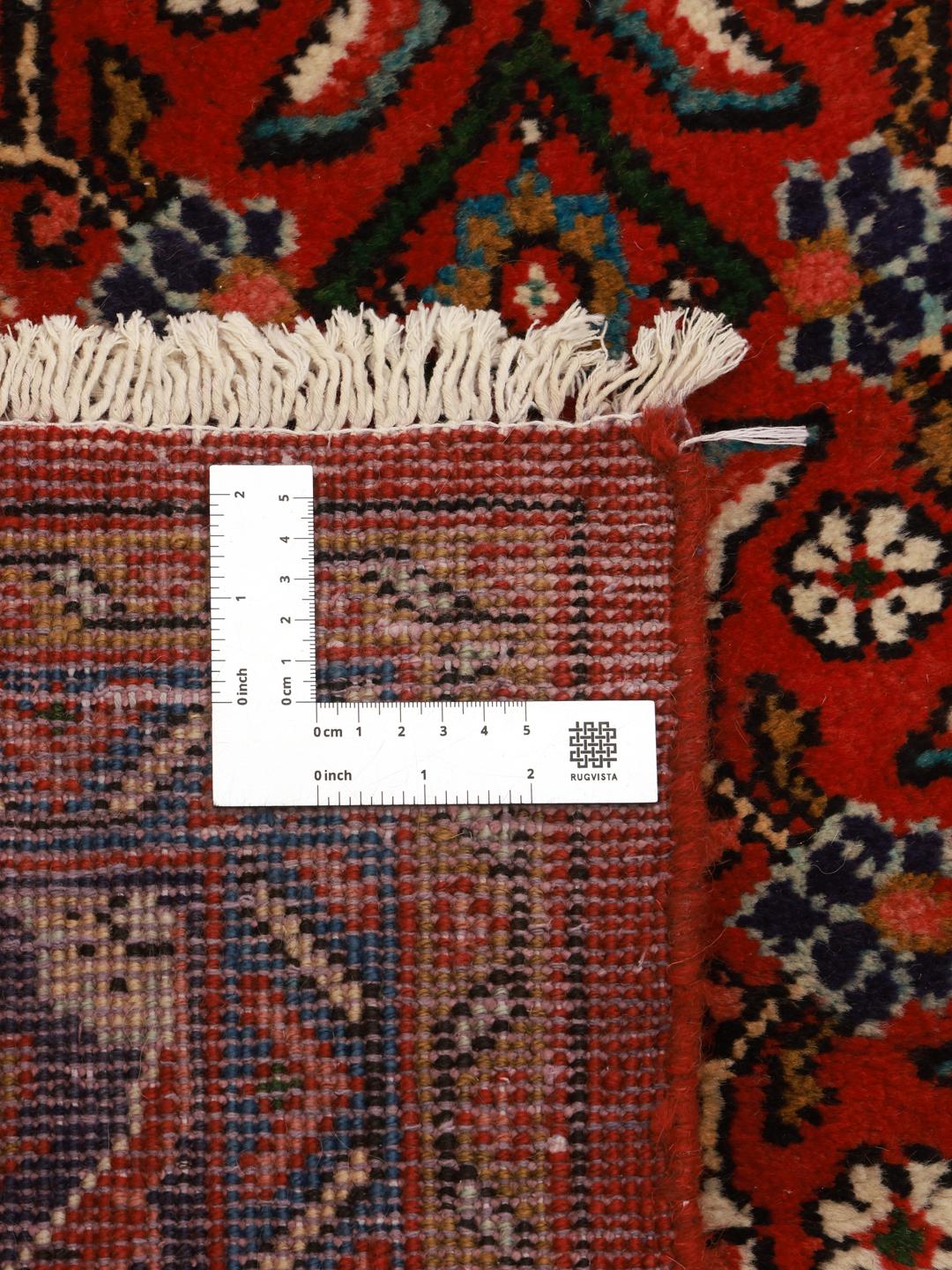 Hand-knotted Hosseinabad rug from the Middle East with a red field and decorative borders.