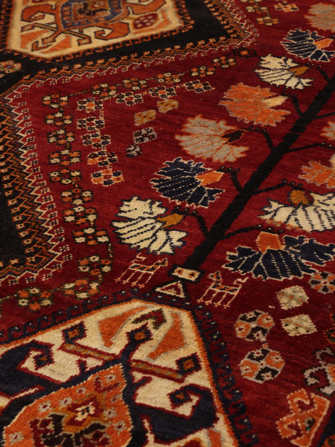 Hand-knotted red and dark-blue tribal rug from the Middle East