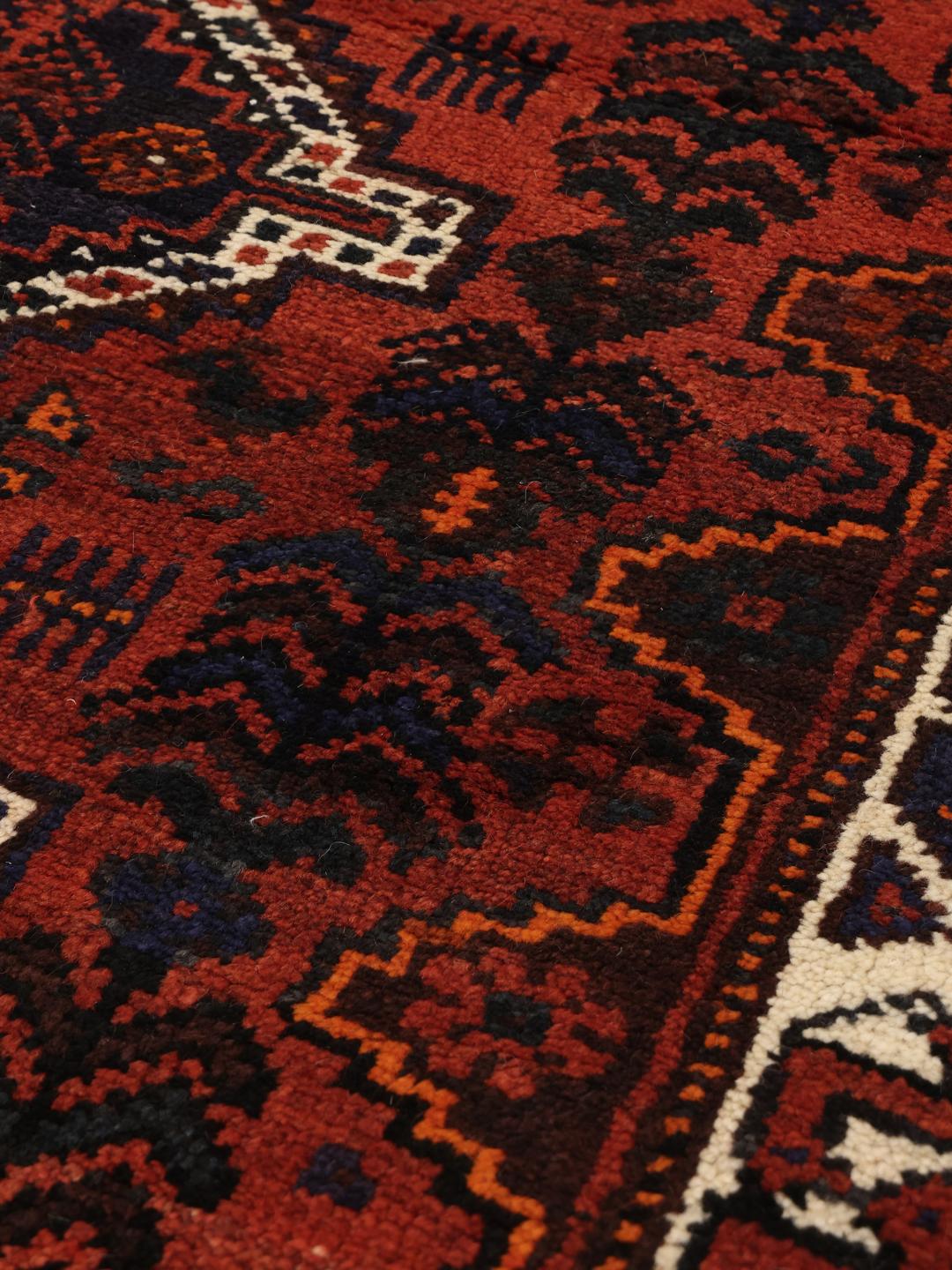 Hand-knotted Shiraz rug from the Middle East in deep red and blue tones