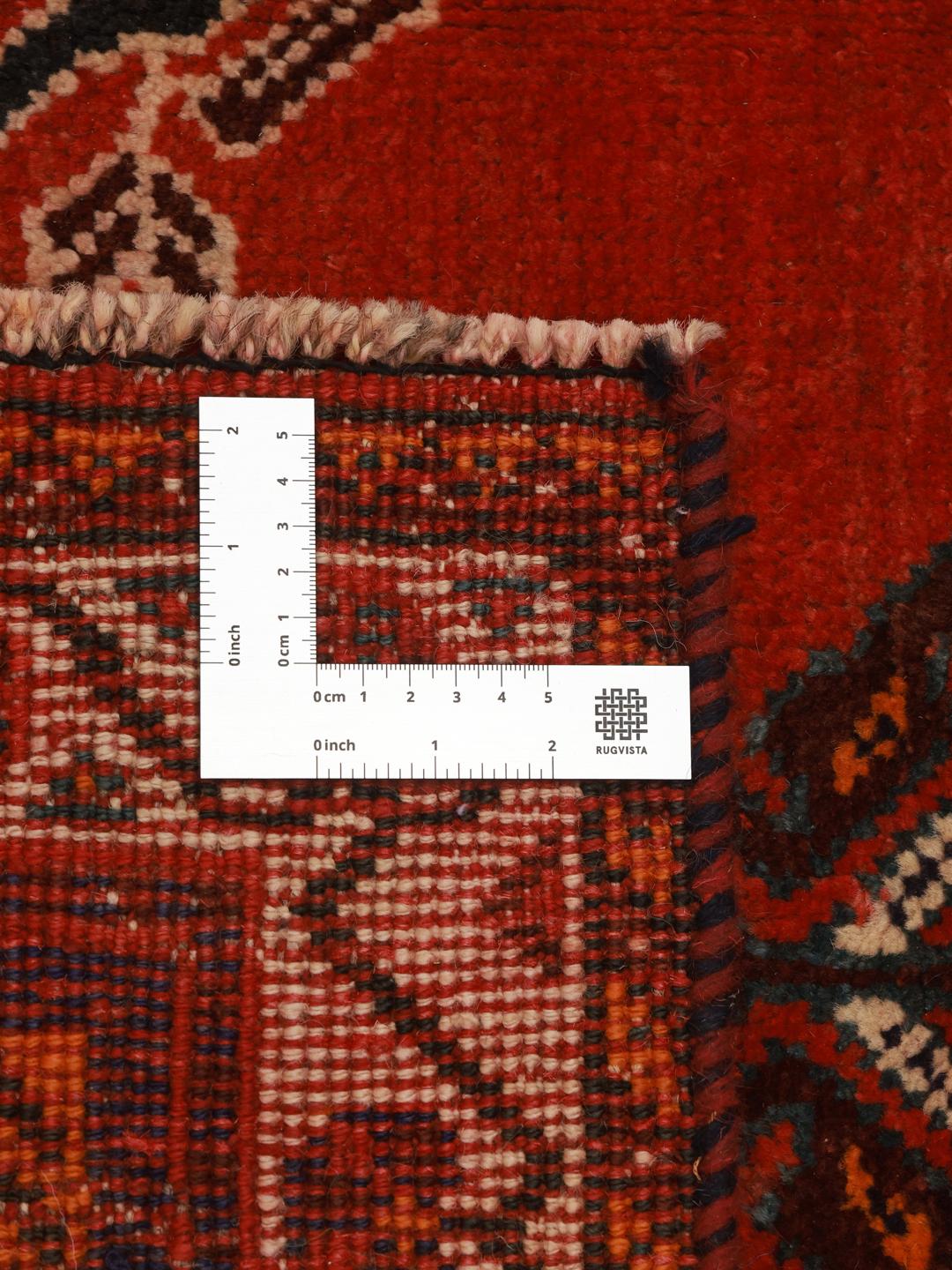 Hand-knotted Qashqai rug from the Middle East in red and deep blue tones