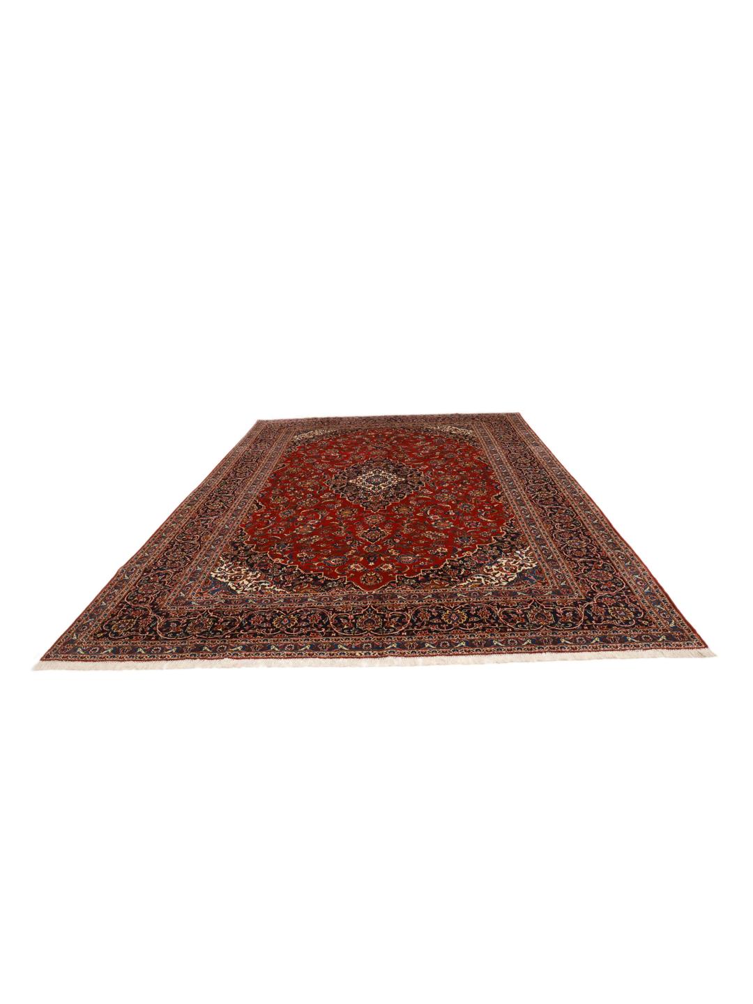 Hand-knotted Keshan rug from the Middle East with a red field and traditional floral medallion.
