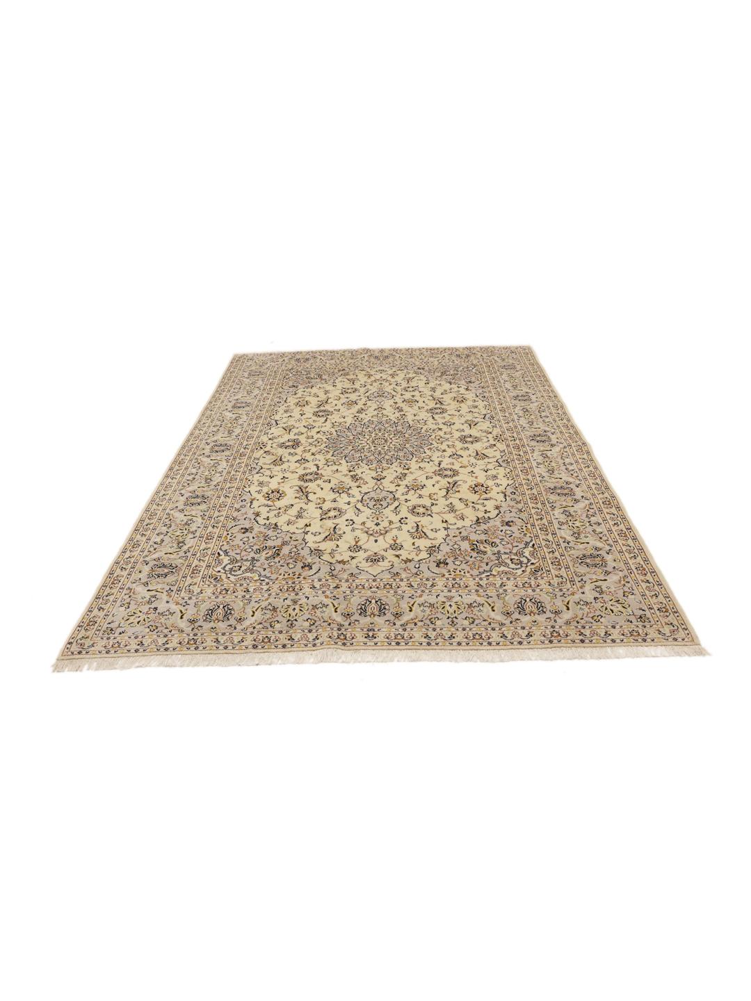 A hand-knotted Keshan rug from the Middle East featuring a beige field with floral patterns.