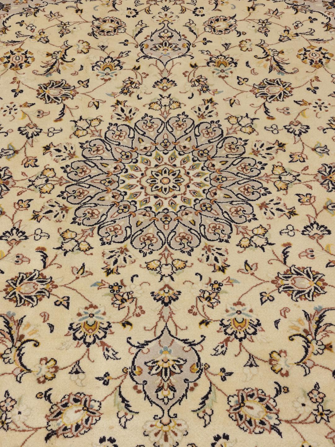 A hand-knotted Keshan rug from the Middle East featuring a beige field with floral patterns.