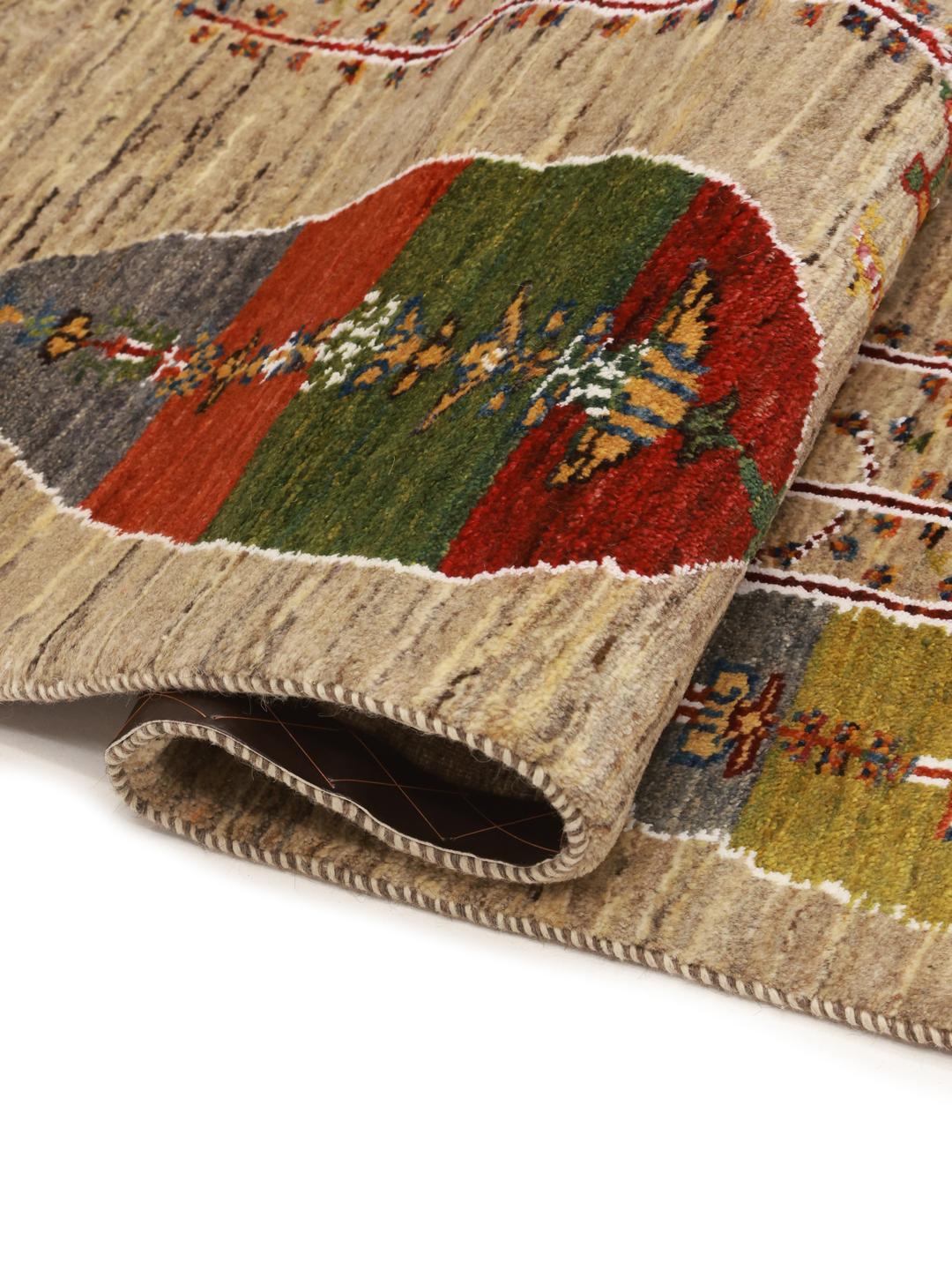 Hand-knotted Gabbeh rug from the Middle East featuring tree motifs in beige and multicolor wool.