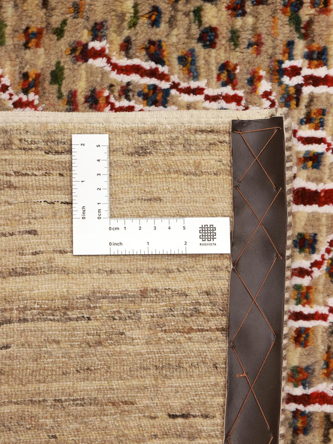 Hand-knotted Gabbeh rug from the Middle East featuring tree motifs in beige and multicolor wool.