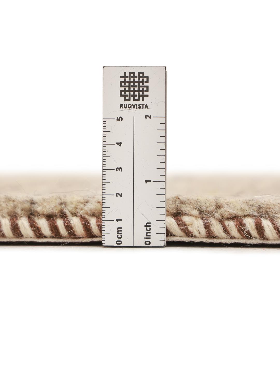 A hand-knotted Gabbeh rug from the Middle East featuring striped earthy brown and beige tones.