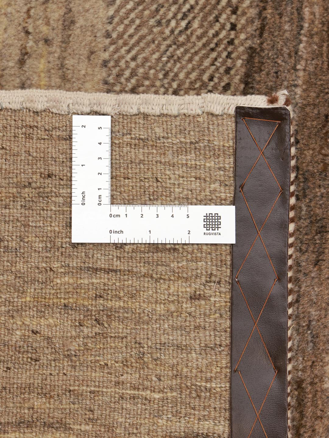 A hand-knotted Gabbeh rug from the Middle East featuring striped earthy brown and beige tones.