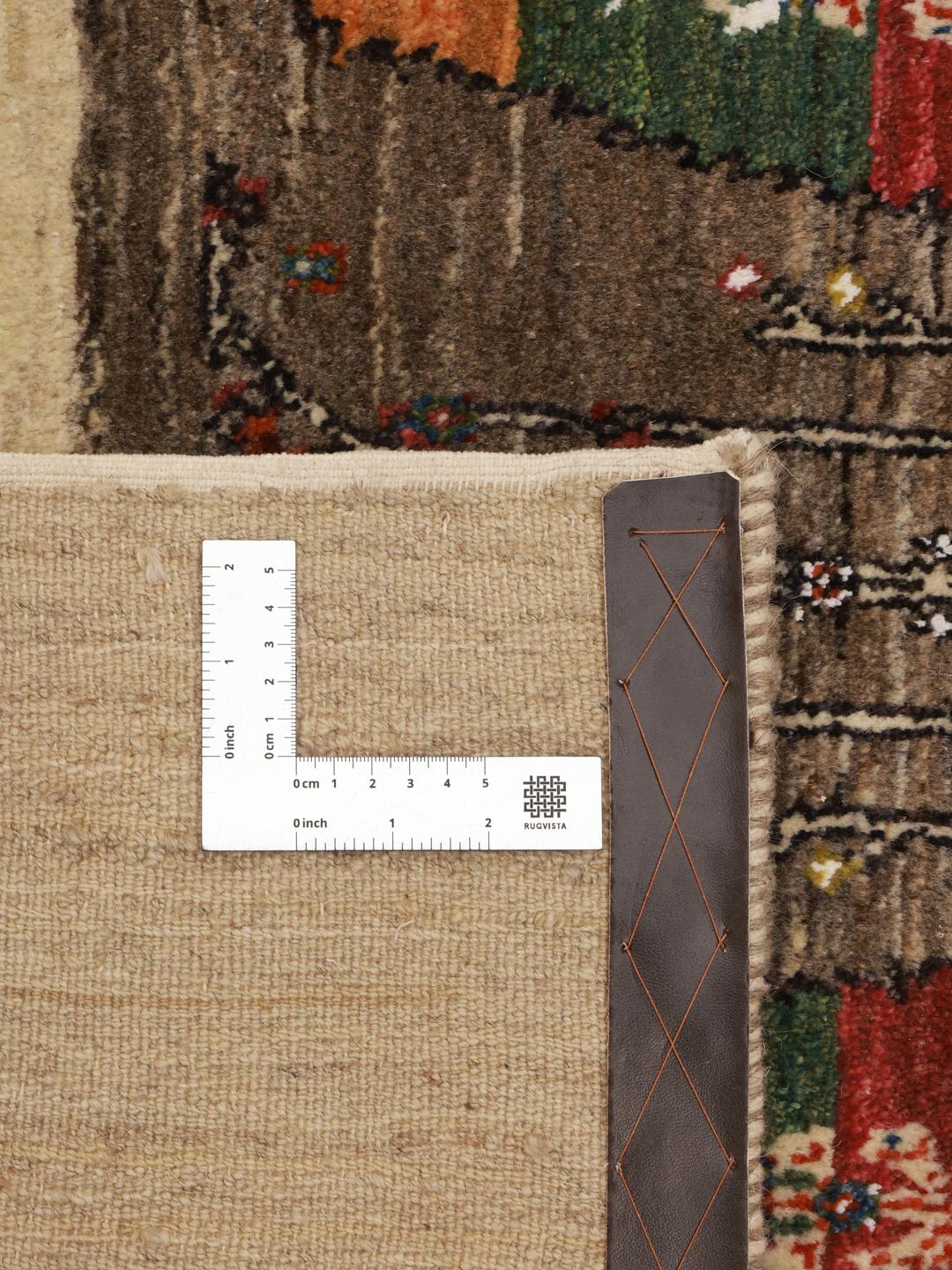 Hand-knotted Gabbeh rug from the Middle East featuring tree motifs in brown and beige colours.