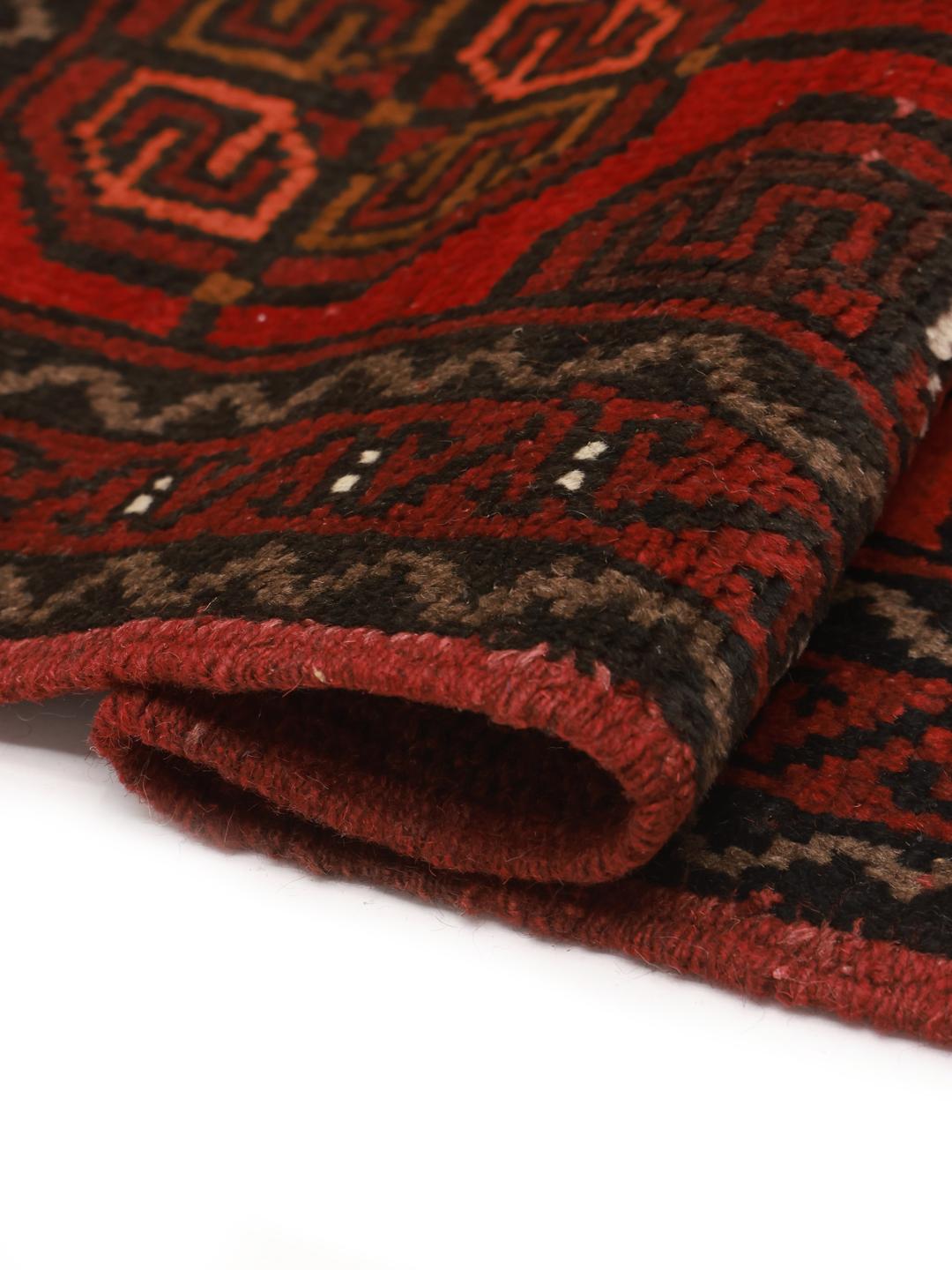 Hand-knotted Turkaman wool rug from the Middle East in dark-red and black