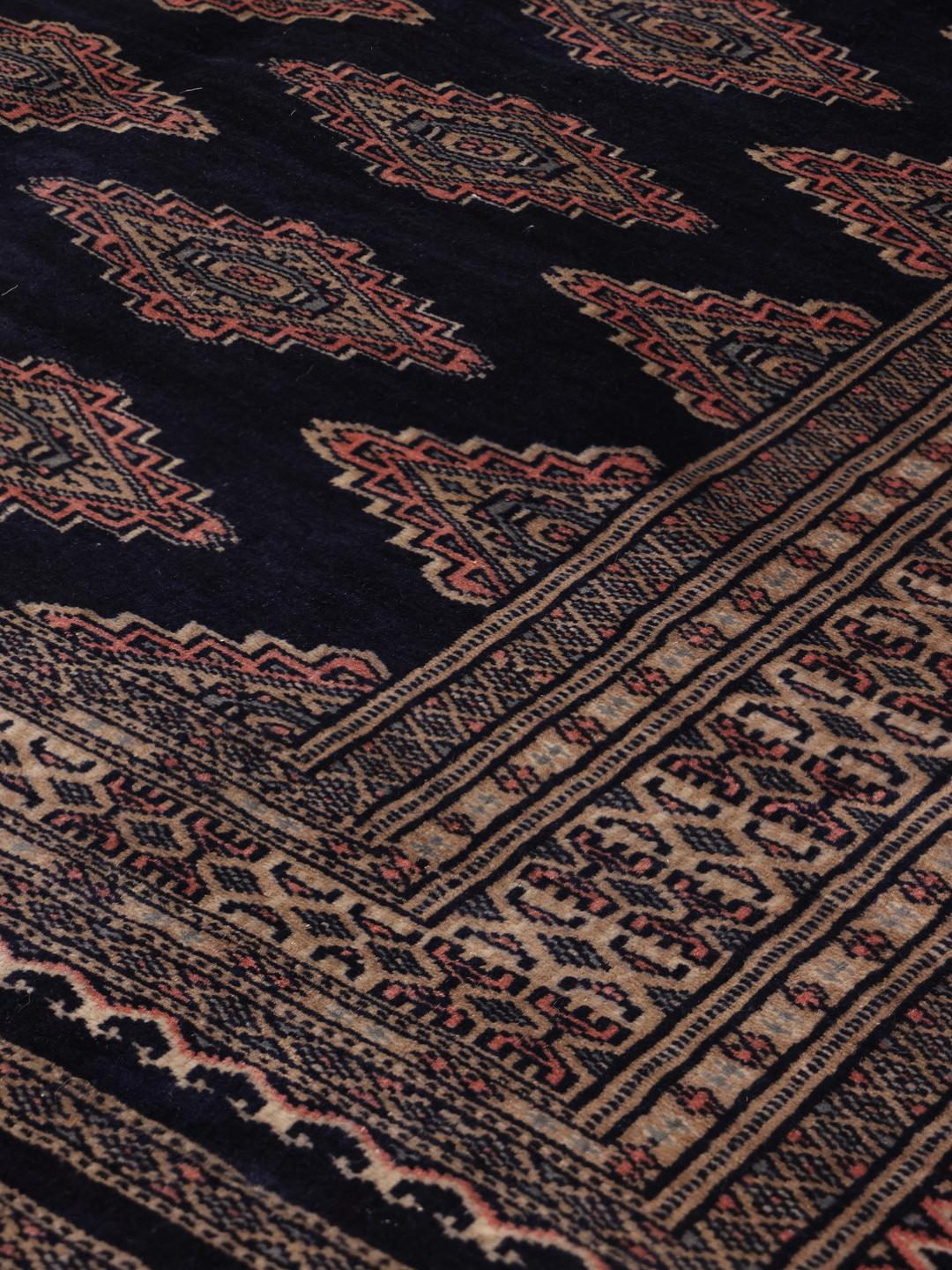 Hand-knotted Pakistan rug with deep blue field and geometric motifs
