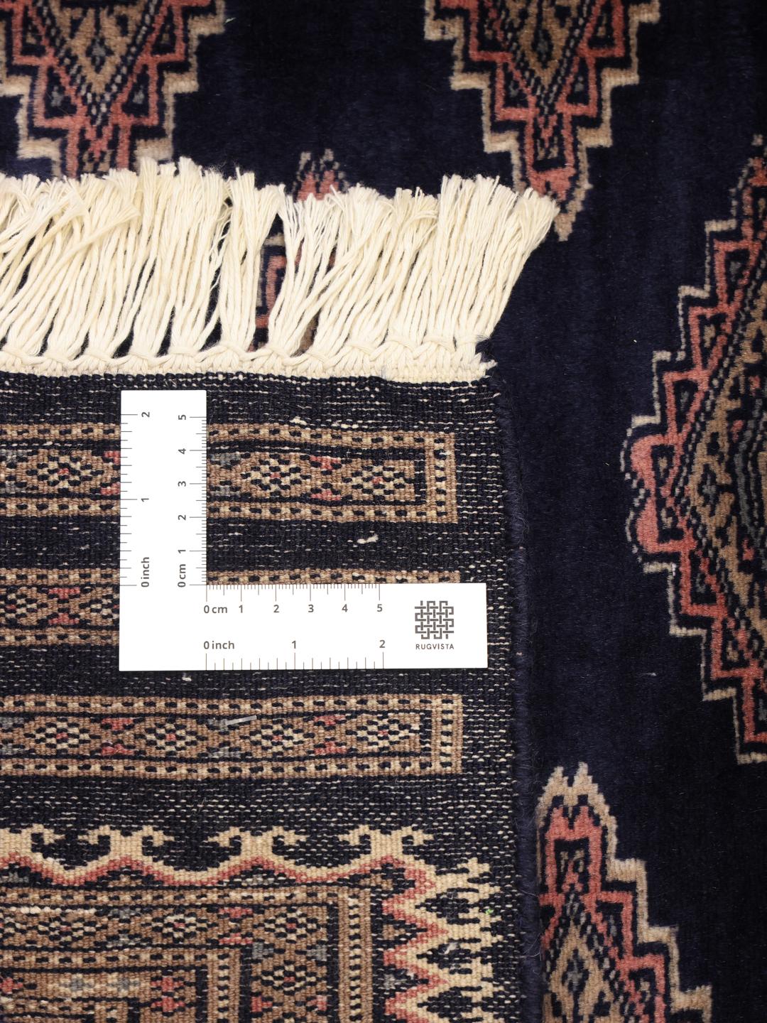 Hand-knotted Pakistan rug with deep blue field and geometric motifs
