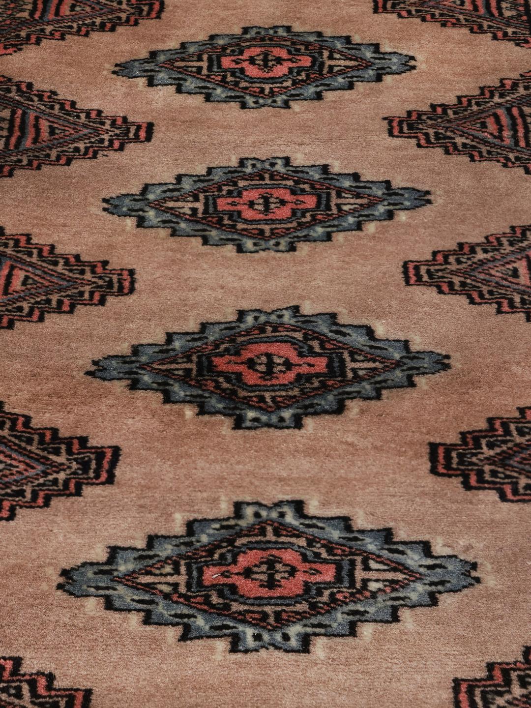 Hand-knotted Pakistani rug with traditional beige geometric motifs