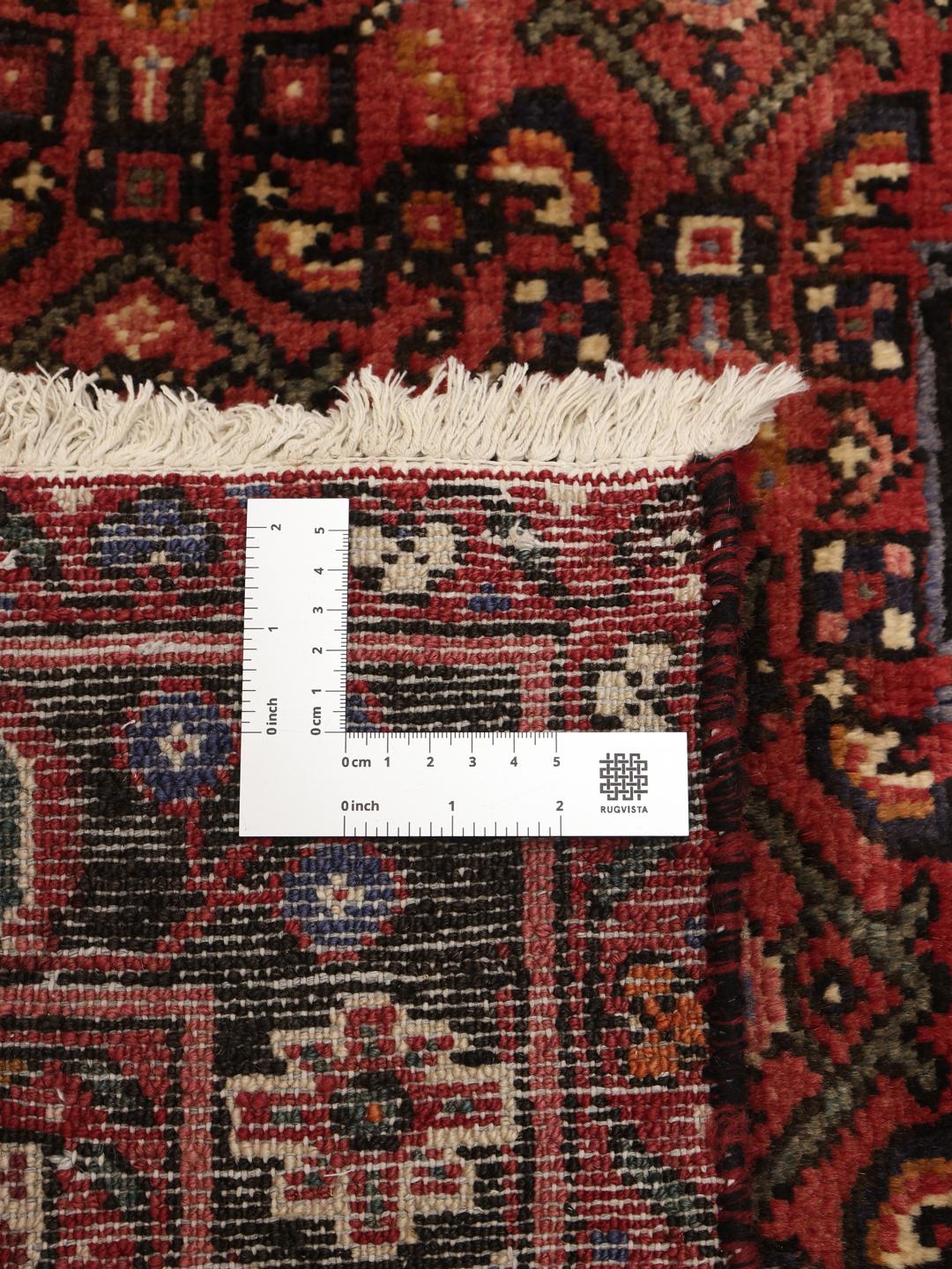 Hand-knotted Hosseinabad rug from the Middle East in dark-red tones