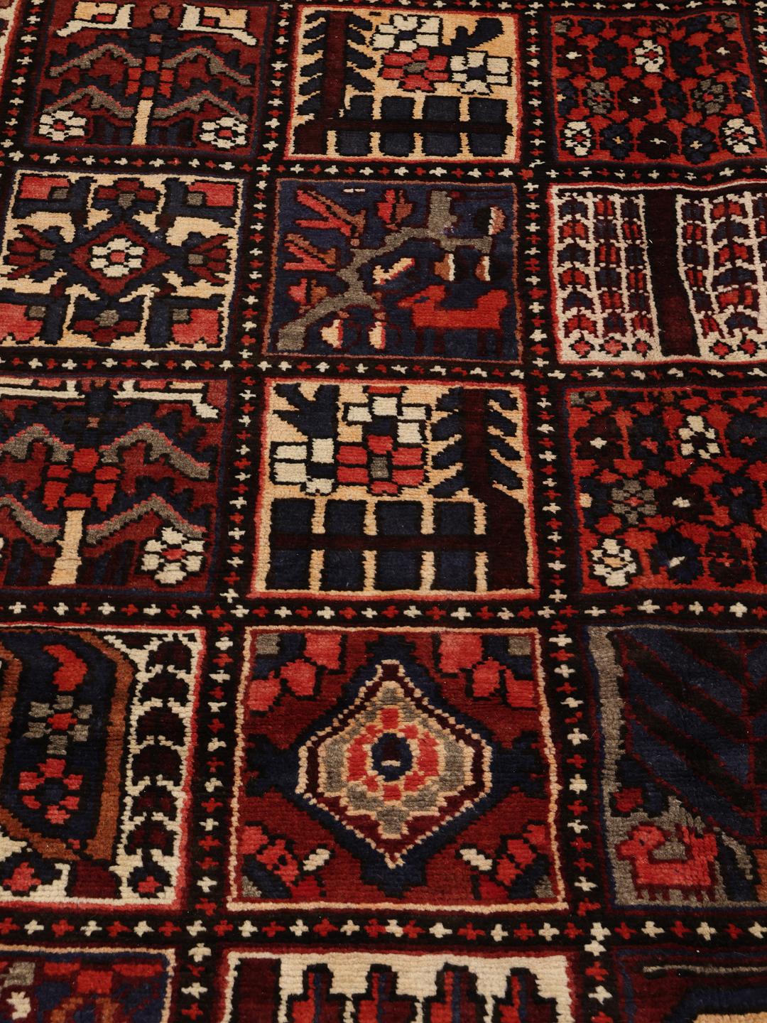 Hand-knotted Bakhtiari rug from the Middle East in dark red and multicolour hues.